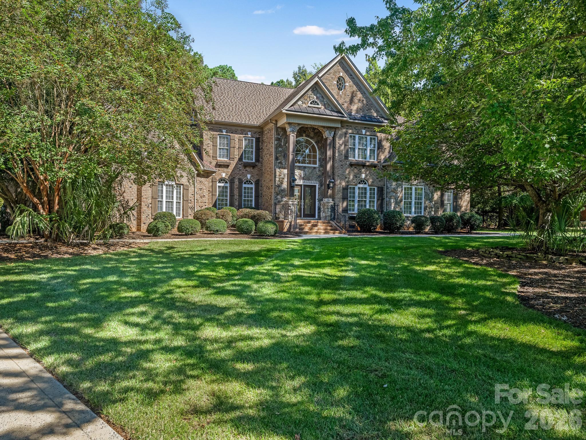 Located on a secluded .98 acre lot within gated Providence Downs, this custom brick and stone estate features a versatile floor plan tailored for modern living. The main level welcomes you with a two-story foyer, dedicated dining and living rooms alongside a home office. The open-concept layout beautifully integrates the kitchen, breakfast area, and a dramatic two-story great room with a window-lined sunroom. The expansive recreation room – complete with a dedicated side entry, fireplace, wet bar and adjoining full bath – offers incredible potential as a second living quarters. The third-level retreat features a media room, flex space suited for exercise, art studio or study and a large, bright bedroom w/ full bathroom. Step outside where a pristine swimming pool serves as the centerpiece of a fenced backyard framed by mature trees. Providence Downs residents gain exclusive access to top-tier community amenities, including a clubhouse, Olympic pool, fitness center, tennis courts, basketball court, soccer field, putting green, walking trails and playground. Be sure to visit the Amenities Center located @ 8723 Kentucky Derby Drive. Zoned for highly sought-after Marvin schools.