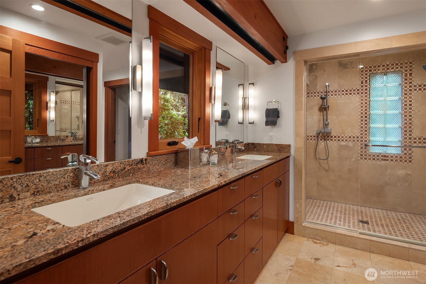 Spa-like ensuite bathroom with dual vanity and walk-in shower