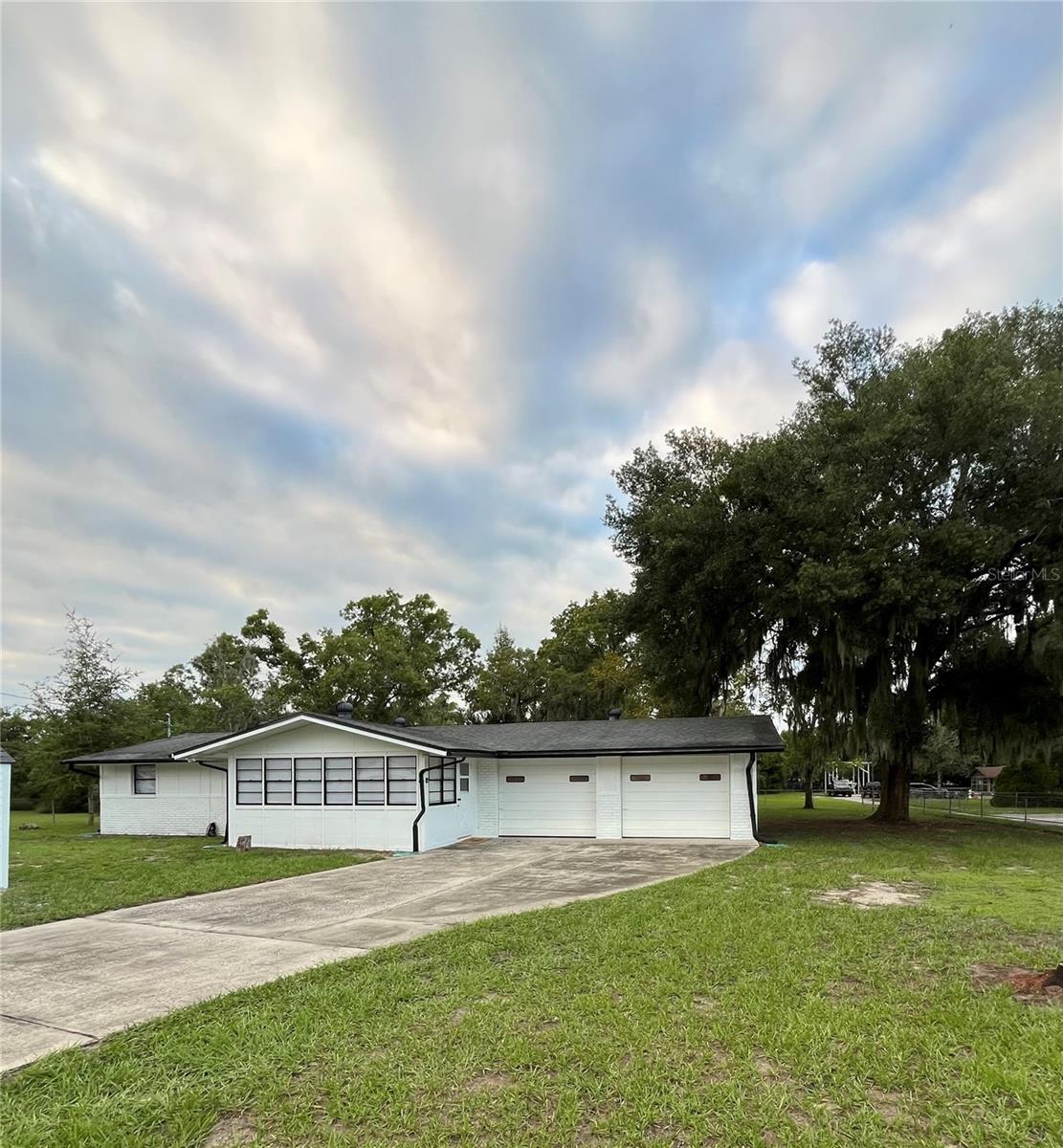 Welcome to this beautifully remodeled 3-bedroom, 2-bathroom home with a 2-car garage, perfectly situated on approximately 0.99 acres! Offering the ideal combination of modern upgrades, privacy, and room to grow, this move-in-ready property is ready for you to call home.Step inside to discover a bright, inviting interior featuring luxury vinyl flooring throughout, fresh interior and exterior paint, and two completely remodeled bathrooms with beautiful, modern finishes. The updated kitchen showcases quality cabinetry and gorgeous quartz countertops, offering the perfect blend of style and functionality for everyday living and entertaining. A beautiful Florida room provides additional living space where you can relax, entertain guests, or simply enjoy views of your spacious property.Enjoy added peace of mind with major 2026 upgrades, including a brand-new AC system and ductwork, along with a new septic tank and drainfield.Outside, the possibilities are endless! Approximately half of the property is already fenced, offering plenty of space for pets, outdoor activities, gardening, or simply enjoying the privacy of your own backyard. The remaining acreage provides an incredible opportunity to bring your vision to life. Subject to applicable zoning, lot-split, and permitting requirements, the additional land may offer potential for future construction, development, or subdivision.Best of all, NO HOA and NO CDD mean more freedom to enjoy your property your way!With nearly an acre of land, extensive renovations, major system upgrades, and a beautiful Florida room, this property offers a wonderful combination of comfort, space, and flexibility.Move right in, spread out, and make it your own! Schedule your private showing today and discover everything this Hudson property has to offer!