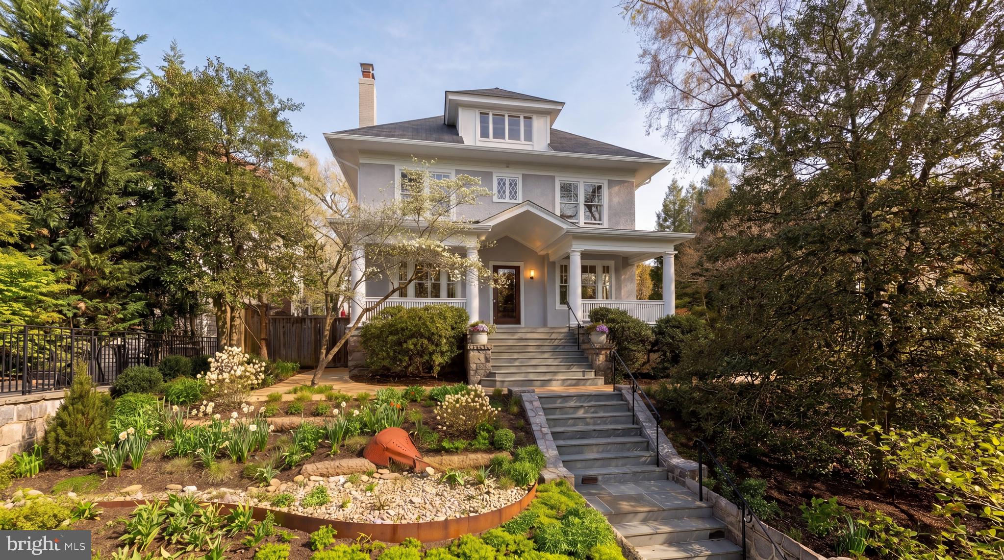 Tucked discreetly along one of Cleveland Park’s most beautiful and storied streets, 3519 Lowell Street NW stands as a soon-to-be icon of timeless residential design, a breathtaking reimagining of a historic home that transcends renovation by establishing an identity both deeply rooted and quietly global. Originally constructed in 1916 as a classic American Four Square, long cited as an exemplar of the form, the residence has been meticulously re-envisioned. A comprehensive renovation, completed in 2023, honors its early 20th-century origins while introducing a refined sensibility shaped by years of living abroad, resulting in a home that feels simultaneously familiar and refreshingly modern. The transformation has garnered international recognition, including being the only North American renovation longlisted for the prestigious Dezeen Awards, and has been featured in national publications such as Dwell and Residential Design, as well as locally in Washingtonian Magazine and the Washington Business Journal, among others.Elevated above the street and approached with deliberate intention, the home enjoys a rare sense of privacy and presence, set apart from the rhythm of urban life. Positioned on an extraordinary double lot spanning 0.30 acres, the property offers a sense of openness and calm increasingly elusive within the city. Sweeping views of the Washington National Cathedral rise above curated gardens, mature trees, and a private meadow, creating a setting both serene and sophisticated. Indoor and outdoor spaces are equally suited to gathering and entertaining, offering the ease of living amid greenery, light, and carefully composed sightlines.The transformation, led by Colleen Healey Architecture in partnership with Lynley Ogilvie Landscape Design, conceived Hidden Meadow as a residence where architecture, landscape, and light are inseparable. A planted meadow framed by Corten planters creates a contemplative pause between the main house and a detached garage and pool house with guest suite above, forming a secluded courtyard rarely found in Washington.At the heart of the project is a deliberate interplay between preservation and invention. Historic sleeping porches were retained and reinforced, while a steel-framed rear volume introduces a luminous kitchen and dining space. Ten-foot sliding doors connect seamlessly to a screened porch with retractable screens and built-in heaters, extending living into the landscape. Subtle shifts in material from warm wood to smooth concrete mark the transition from historic to modern with clarity and intention.Inside, approximately 7,400 square feet reveal six en suite bedrooms, each with its own private bath, along with two additional suites with full baths and kitchenettes, supporting true multigenerational living. Two offices and a sequence of living spaces offer flexibility for work, study, or leisure. The original three-story staircase anchors the home, while new interiors introduce sculptural plaster forms, gentle curves, and a serene palette of natural materials.The lower level includes a fully equipped gym, while features such as dual laundry areas enhance everyday convenience. Skylights and soaring ceilings with exposed beams amplify light and openness, while reflective surfaces extend garden views deep into the interior.The exterior blends Accoya siding and expansive glass with the original façade, complemented by a detached garage and pool house. Lush gardens frame a heated pool and outdoor living areas, ensuring privacy for summer gatherings, all within walking distance to top schools and parks.3519 Lowell Street NW is not simply restored, but redefined, a rare synthesis of history, global influence, and modern craftsmanship.