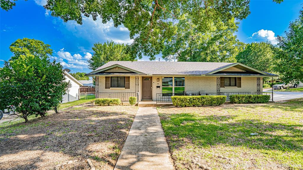Charming Updated Home in Prime Grapevine Location! This beautifully updated home sits on a spacious corner lot shaded by mature trees and just minutes from historic downtown Grapevine, Southlake, and top dining, shopping, and entertainment options. Step outside to your own private retreat featuring a custom extended covered patio with cedar tongue and grove ceiling, granite countertops, built-in grill, oversized fan, and TV mount—perfect for entertaining year-round. The board-on-board privacy fence and custom gate add both charm and seclusion, while the extra driveway space is ideal for a trailer or boat. Inside, enjoy generously sized rooms, updated oversized bathrooms, abundant natural light, and granite countertops throughout. Plenty of closet space and an included refrigerator make this home move-in ready. Work bench in garage. Easy access to major highways and just a short drive to DFW Airport. A must-see in the heart of Grapevine!