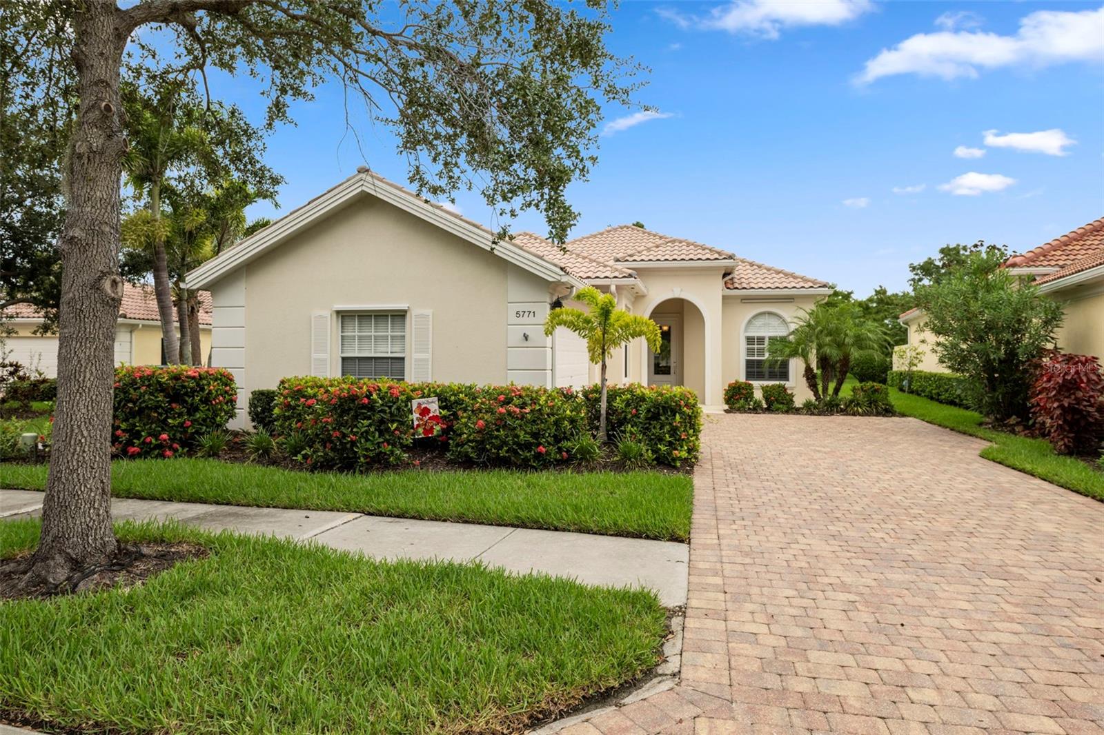 Under contract-accepting backup offers. Welcome to your dream home in the highly sought-after, resort-style VillageWalk on Palmer Ranch. This DiVosta-built Oakmont model offers solid poured concrete reinforced construction, providing exceptional durability and peace of mind. Situated on a premium waterfront lot, this 3-bedroom, 2-bathroom plus den residence is immaculate and move-in ready. The extended floor plan features ten- and twelve-foot ceilings, enhancing the open, airy feel throughout. Enjoy newer flooring in the great room, bedrooms and den, along with plantation shutters in the den and guest rooms. The primary suite boasts a large walk-in closet and an elegant ensuite bath with soaking tub, separate shower, and vanity. Wake up every day to serene water views from the expansive great room, where walls of glass bring in the light and beauty of the outdoors. The kitchen is stylish and functional with ceramic tile floors, stainless steel appliances including a brand-new range and microwave, and a breakfast bar perfect for casual dining. A Trane A/C system (installed in 2021) and a newer hot water heater add to the home's long-term comfort and efficiency. Relax or entertain on the spacious screened lanai overlooking the tranquil water — an ideal spot to unwind or host guests. VillageWalk offers a vibrant, gated community lifestyle with world-class amenities, including: 6 Har-Tru lighted tennis courts, pickleball, bocce ball, and basketball courts, Clubhouse with event space, card rooms, a library, heated resort-style pool with a Tiki bar, On-site restaurant with full bar, gas station, hair salon, boutique, and a 24-hour manned security gate. Scenic walking and biking trails winding through lakes, bridges, and lush tropical landscaping. Located just minutes from Siesta Key Beach, Costco, medical offices, shopping and dining. Don’t miss this rare opportunity to own a waterfront gem in one of Sarasota’s premier communities. Call today for your private showing!