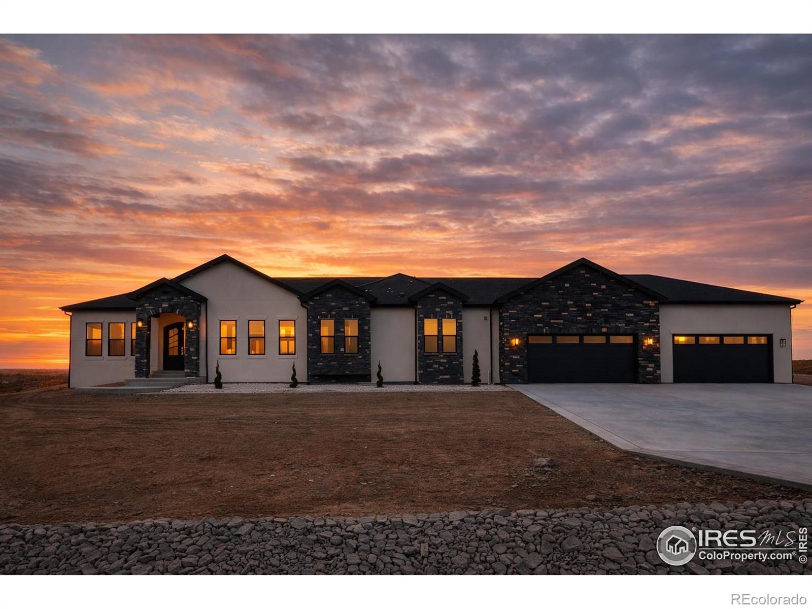 Experience the rare blend of modern luxury and Colorado ranch living in this exceptional new-construction residence, thoughtfully designed for those who value space, comfort, and intentional living. Set on a generous lot within a peaceful ranch-style community, this home offers the freedom of open surroundings with the convenience of nearby city access. From the moment you arrive, the striking modern elevation and covered porches invite you to slow down and enjoy the setting. Inside, expansive windows and soaring ceilings fill the open-concept layout with natural light, creating an effortless flow between the great room, dining area, and chef-inspired kitchen, ideal for both intimate moments and memorable gatherings. A statement fireplace anchors the living space, adding warmth and character year-round. The main-level primary suite is a true retreat, offering privacy, comfort, and a spa-like bath designed for relaxation at the end of the day. Additional main-floor bedrooms and a dedicated office provide flexibility for family, guests, or working from home. The fully finished basement extends the lifestyle even further, featuring multiple bedrooms and baths, an entertainment space, bar area, gym, and room to host, unwind, or create a multigenerational living environment. Every space has been designed with purpose and ease in mind. A rare four-car garage offers abundant room for vehicles, storage, and recreation, perfect for those who embrace an active Colorado lifestyle. Surrounded by wide-open skies and a sense of breathing room, this ranch-style neighborhood offers a peaceful escape while remaining minutes from Brighton's shopping, dining, schools, and commuter routes to Denver and DIA. This is more than a home, it's a place to live expansively, gather meaningfully, and enjoy the luxury of space, both inside and out