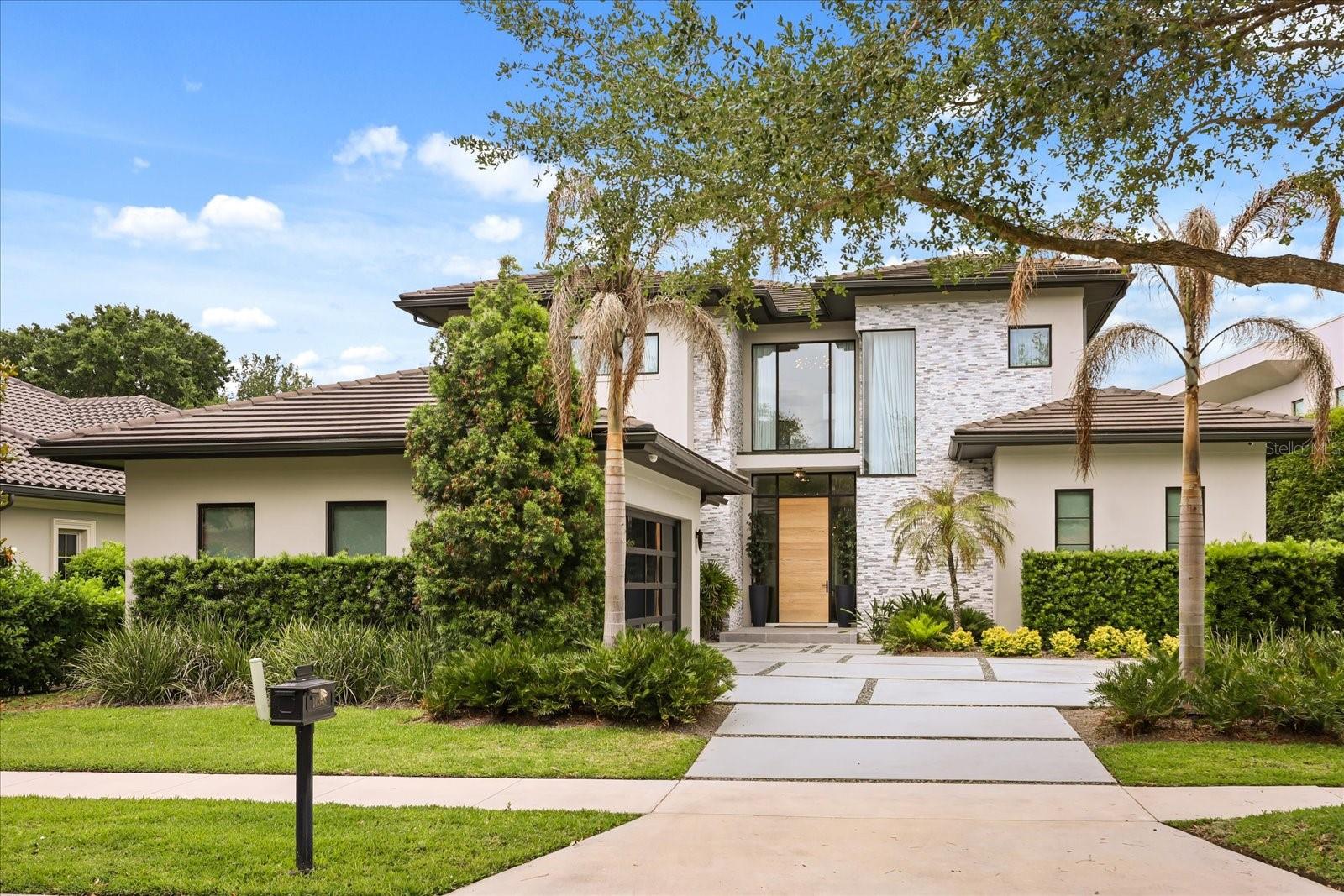 Nestled within the exclusive gated enclave of Lake Nona Golf & Country Club, 10348 Kensington Shore Drive presents a rare 2022-built modern masterpiece that redefines sophisticated living.    As you enter, your eye is immediately drawn to the exquisite marble flooring that flows throughout the 3,964 square feet, complemented by custom warm lighting that bathes every room in an elegant glow.  The gourmet kitchen serves as the heart of the home, boasting an oversized waterfall island, premium stone countertops, and extensive custom cabinetry — an entertainer’s dream perfectly suited for intimate family dinners or grand gatherings. This seamless open-concept design flows into sophisticated living spaces, where a sleek electric fireplace creates an intimate ambiance. Expansive sliding glass doors invite abundant natural light and effortlessly connect the indoors to the breathtaking outdoor sanctuary.    Each of the four generously proportioned bedrooms features its own luxurious en-suite bath. The main-level primary suite is an exceptional private retreat, complete with a spa-like bathroom, oversized walk-in closet, and private laundry. An upstairs loft provides versatile space for a refined home office, media room, or additional gathering area.Discerning details abound, including a sophisticated smart home system, dual upgraded refrigerators, dual dishwashers, dual washers and dryers, and designer ceiling fans throughout.    The private quarter-acre lot offers unparalleled tranquility, overlooking two serene ponds with no rear neighbors. This resort-style backyard oasis features a heated pool and spa, a fully equipped screened outdoor kitchen, two custom fire pits, an elegant outdoor fireplace, and meticulously landscaped gardens — creating the ultimate setting for both intimate evenings and unforgettable entertaining.Situated in the community’s most desirable walkable location, residents enjoy effortless access to the championship golf course, resort-style pool, world-class fitness center, tennis and pickleball courts, and the exclusive clubhouse with fine dining. This premier gated community provides 24/7 manned security, round-the-clock concierge services, and a secure, family-oriented lifestyle where children can safely explore by foot or golf cart.This is Lake Nona living at its absolute finest!Ready to experience this exceptional home? Let’s schedule your private tour today.
