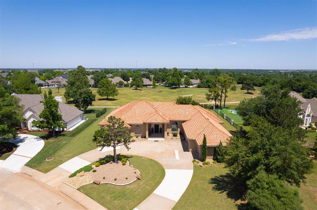 Mediterranean beauty perched on a lovely .60 acre mol corner golf course lot in Oak Tree. The current owner has completed EXTENSIVE landscaping and hardscaping to create a resort-inspired setting. Step into an entertainer's dream with two spacious contiguous living areas, formal and casual dining spaces and a perfectly appointed kitchen that would make a pro-chef swoon! NEW Viking commerical grade range/oven, NEW Sub-Zero refrigerator, JennAir dishwasher, built-in microwave, wine frig, pantry and breakfast bar. A spacious office with NEW wood-look tile floors and French doors for privacy is tucked away at the front of the home for a nice private work space. High ceilings and a multitude of floor to ceiling windows usher in an abundance of natural light. Fabulous plantation shutters and handy builtins can be found thru out the home. All bedrooms have NEW carpet. The primary bedroom offers a spa-like ensuite bathroom w/double vanity, jetted tub, large walk-in shower & TWO walk-in closets. Three secondary bedrooms, all have walk-in closets; one has ensuite bath, the other two have a Jack & Jill bath with two sink vanity. The backyard is the crowning glory of this gem of a home offering a spectacular, unobstructed view of 11 E Fairway. Current owner replaced garage doors & openers, put in new gutters, installed an F-5 storm shelter, replaced both water heaters and painted entire interior and exterior. HVAC was taken up & over in 2013 w/floor vents filled in. See supplements for a list up updates and improvements.