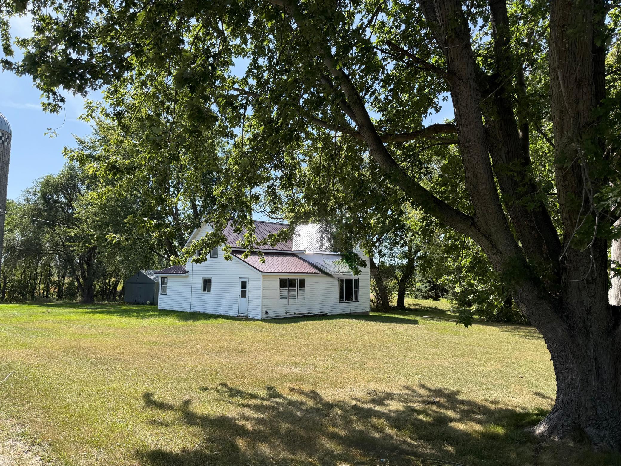 3.5 ACRES Here is an opportunity to get so much more than a house. this one and 1/2 story  (4) bedroom one full bath, kitchen with, oven and microwave. Laundry room with washer and dryer. Unfinished basement. Propane heat and electric water heater. New mound septic system installed in 2022. Grain bin with Sweep auger. Silo with unloader. Building A -36'x45'x10' ,S. Overhead door 12'x9',17' West sliding door  36'x21' cold storage. dirt floor36'x24' heated storage, with concrete floor, LP forced-air heater, and service door. Building B - 90'x14'x12' machine shed. 18' West sliding door 23' South Opening, Dirt floor, lights.Building C  26'x48'x9' 6'x6.5' Overhead door Heated with LP Forced air, Concrete floor, service door, water. Building D 30'x48'x10'14' sliding door, concrete floor, cold storage, service door, has waterBarn 32'x64'Round roof Hay loft has water Attached loafing barn, 40'x45'x10' with 15' openingBuilding F  45'x30'x9(2) 9' sliding doors 3/4 concrete floor, LP plumbed to building, has water. Red roof buildings new roof in 2019all buildings have power 1 Ritchie waterer.All measurements are estimates buyers and buyer agents are encouraged too verify measurements on their own '