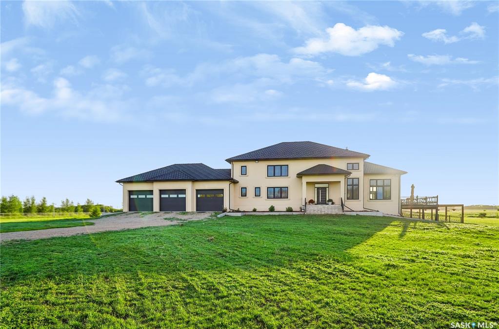 LUXURY ACREAGE LIVING JUST 15–20 MINUTES FROM SASKATOON!Experience the perfect blend of luxury, privacy, and country living on this exceptional 10-acre estate with convenient access to Highway 11. This impressive 4,916 sq. ft. two-storey executive home is constructed entirely with energy-efficient Insulated Concrete Forms (ICF), including the home, attached triple garage, shop, and barn. This superior construction provides exceptional strength, durability, sound insulation, and year-round energy efficiency.Designed for lasting value, the home is topped with a premium rubber tile roof backed by a lifetime warranty, offering outstanding protection and peace of mind.Step inside and be welcomed by a spectacular living room featuring soaring 19-foot open-to-above ceilings, creating a grand yet inviting atmosphere. Premium German windows flood the home with natural light, while tile flooring throughout and countless custom upgrades showcase exceptional craftsmanship and timeless elegance.Thoughtfully designed for comfortable family living and entertaining, the home offers 5 spacious bedrooms and 6 bathrooms, including three generously sized upper-level bedrooms, each with its own private ensuite. A fully developed basement provides additional living space for recreation, entertaining, or accommodating guests.The heated and painted triple attached garage offers abundant space for vehicles, storage, and hobbies. Outdoors, this remarkable property features a horse setup, barn, volleyball court, and a fully fenced perimeter with solar lighting. Beautifully landscaped trees and shrubs along the fence line enhance privacy while creating a picturesque, park-like setting.Designed for LOW-MAINTENANCE OWNERSHIP AND ECONOMICAL YEAR-ROUND LIVING, this exceptional acreage combines premium construction, elegant finishes, and outstanding outdoor amenities in one extraordinary package.