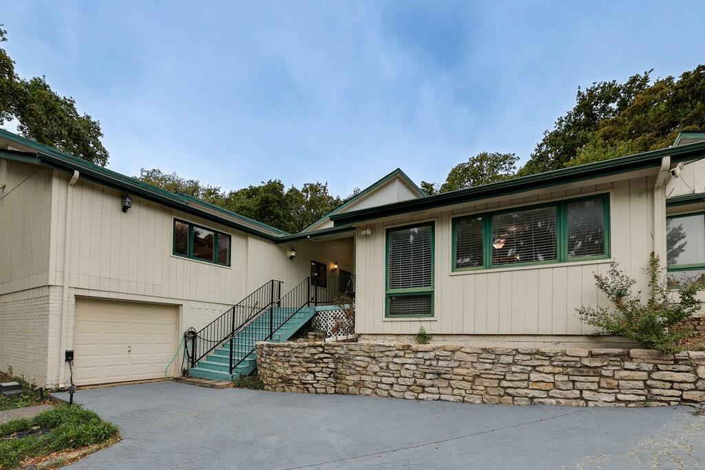 Price Improvement. Vacant. This home offers 6-bedrooms, 4-baths, with 3,807 sq ft home on quiet North Arlington cul-de-sac ready for immediate move-in. Buyers: this one will not last at the new price. Curb appeal with classic front porch and swing draws buyers in the moment they pull up. Dining room with hardwood floors and plantation shutters perfect for hosting. Living room featuring stone wood-burning fireplace, built-in bookcases, and that wow-factor library vibe owners love to show off. Unique spiral staircase to private loft adds character and extra flex space everyone fights over. Kitchen boasts double ovens, marble counters, and flows seamlessly for entertaining. Primary suite with skylight, jetted tub, separate shower, dual vanities, and double closets checks every luxury box. The backyard has a pool and hot tub and allows a great place to relax and recharge. Whole-house Generac generator powered by dual 80-gallon propane tanks eliminates power-outage objections. 3-car garage configuration (2-car + separate 1-car) gives buyers parking and storage. Minutes to schools, parks, shops, and restaurants yet tucked away on peaceful court. Bring your buyers now before grabs it. Easy to show. Call CSS to get instant access.