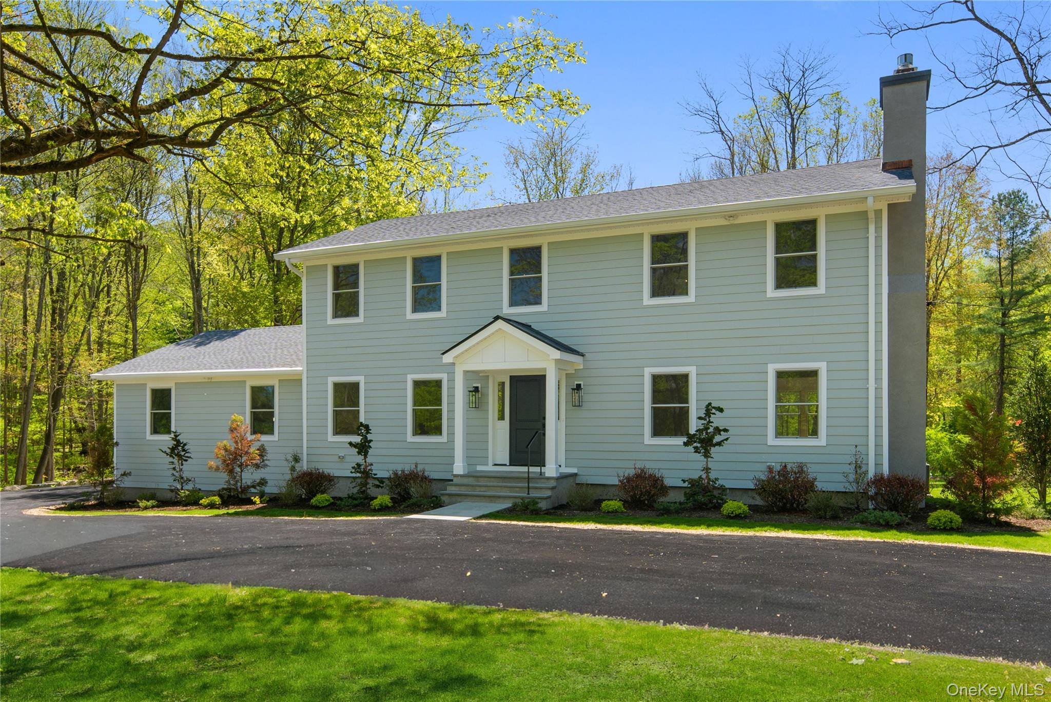 Welcome to this exceptional, like-new 4 bedroom, 3.5 bath residence set on two serene, wooded acres in sought-after Armonk. Thoughtfully reimagined from top to bottom, this home offers a seamless blend of modern design and effortless living, with all new sheetrock, siding, windows, roof, wood floors, kitchen, baths, mechanicals and more!A dramatic two story entry introduces sunlit interiors and refined finishes throughout. The stunning chef-inspired kitchen features striking two tone cabinetry, quartz countertops, an oversized island, eat-in-kitchen and curated open shelving, flowing beautifully into an expansive living area designed for entertaining and everyday comfort.Sliding glass doors open to a sophisticated, oversized deck with sleek cable railings, creating a perfect setting for outdoor dining and relaxation amid a tranquil natural backdrop.The main level is completed by an elegant dining room, inviting living room with gas fireplace, powder room, and laundry.Upstairs, the primary suite offers a true retreat with a luxurious new bath showcasing dual vanities and an oversized glass enclosed shower. Three additional bedrooms and a beautifully appointed hall bath complete the upper level.The finished lower level provides exceptional flexibility with a full bath, ideal for recreation, workspace, or gym. Privately set on two picturesque acres, this property offers a rare combination of peace and proximity to Armonk, Greenwich, Bedford, Metro North, and major airports.