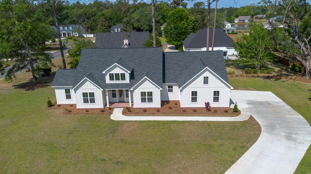 Nestled on a beautiful cul-de-sac in the desirable Shallow Brook Farm community, this stunning home offers the perfect blend of peace, space, and convenience—just 20 minutes from Tallahassee and 10 minutes from downtown Thomasville.    As you enter the neighborhood, you're welcomed by scenic lake views that set the tone for the tranquility Shallow Brook Farm is known for, along with spacious homesites that provide privacy and a relaxed lifestyle.    This thoughtfully designed 4-bedroom, 2.5-bath home features 10-foot ceilings throughout, with elevated 11-foot tray ceilings that enhance the open and airy feel. The floor plan is both functional and inviting, offering a formal dining room, breakfast nook, and a spacious living area filled with natural light.    The kitchen is a standout, complete with quartz countertops, stainless steel appliances, gas range with vent hood, built-in microwave in the island, and abundant cabinetry—perfect for both everyday living and entertaining.    The primary suite offers a generously sized bedroom, while additional features include a two-car garage, a large storage room above the garage, and a professionally designed interior with carefully curated finishes throughout.   Exterior highlights include Hardie board siding, brick skirt accents, and beautiful herringbone brick pavers on both the front and rear porches, complemented by upgraded landscaping that enhances the home's overall appeal.    This home offers a rare combination of quality craftsmanship, thoughtful design, and a peaceful setting—truly a must-see.   Schedule your private showing today with your favorite REALTOR.  Seller is a licensed real estate broker in the state of Georgia, license #340473.