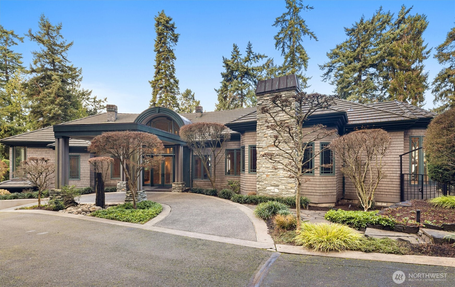 Defined by natural materials, abundant light, & sculptural, softened architecture, this refined residence offers a calm, intentional approach to Northwest luxury living. Set on almost 1/2 an acre of meticulously manicured grounds, offers breathtaking views of the Sound, providing a serene treehouse-like retreat. The custom floorplan highlights a spacious kitchen with oak cabinets and beautiful hardwood floors, perfect for both daily living and grand entertaining. The luxurious primary suite features a private patio, large walk-in closet, and a five-piece bath with a soaking tub and chandelier. With three additional bedrooms, a media room, office, and a grand wine cellar, this estate also includes a detached 1-bed, 1-bath ADU for guests or rental income. Enjoy five garage spaces and unparalleled privacy in this once-in-a-lifetime home!