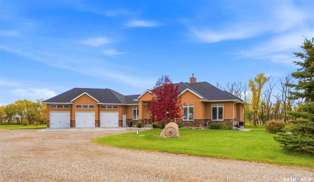 Welcome to 70 Silver Willows Drive in the RM of Laird, a gated fully fenced 15 Acre acreage located approximately 20 minutes from Saskatoon. This 1,792 sq/ft home offers 5 bedrooms, 3 bathrooms, and a functional layout with plenty of space for family living. Step inside to a welcoming home thoughtfully designed with family in mind. The main floor features a mudroom with laundry and walk thru pantry to the kitchen. The kitchen is beautifully appointed with ample cabinetry, quartz counter tops, and a large island and flows seamlessly into to the dining and living areas. A gorgeous woodstove anchors the living room, while large windows provide natural light. Dining room offers access to the deck for all year round BBQ. The primary suite offers a relaxing retreat complete with a walkin closet and private ensuite with a soaker tub. Two additional bedrooms and a full bathroom complete the main floor living space. The fully developed basement features two bedrooms, a large family room, den, storage and a dedicated games room with epoxy flooring and wall boarding, ideal for sports activities and recreation. The triple car garage offers excellent space for vehicles, gym area and storage. Outside, this property truly shines! A WiFi enabled gate entrance welcomes you to the 15 acre property which includes a heated workshop, horse barn, chicken coop, storage shed, riding arena, and fenced paddocks. There is no shortage of ways to enjoy the outdoors with garden boxes with irrigation, a basketball court for family fun, a dedicated fire pit area perfect for relaxing under the prairie skies. Whether you’re looking to pursue your equestrian interests or enjoy country living, this acreage offers a rare combination of space, functionality, and lifestyle. Enjoy the freedom of  a fully fenced 15 acres, the convenience of being just 20 minutes from Saskatoon, and the opportunity to make this beautiful gated acreage your own! Properties like this are a rare find don't miss out Call today!