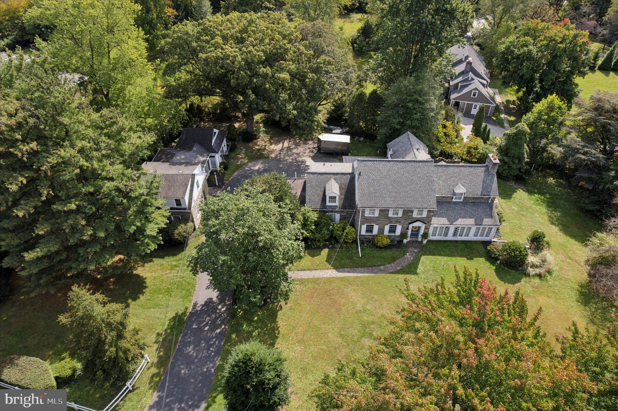 Step into the grandeur of this residence featuring five spacious bedrooms and four elegantly appointed bathrooms. The heart of the home is its expansive living room, complete with a cozy fireplace framed by refined built-ins. Architectural details such as columns, crown mouldings, and decorative mouldings add to the sophisticated ambiance. The double staircase provides an elegant transition between levels, leading to a luxurious primary ensuite with a separate shower and a generous walk-in closet.This home is designed for both comfort and style, with a full basement offering ample storage and opportunities for customization. Enjoy the charm of exposed brick and the convenience of a private entrance, enhancing both aesthetics and privacy.Carriage House:The charming carriage house complements the main residence, offering a large living space with parquet floors and two stately fireplaces. The built-ins and intricate millwork speak to the home's attention to detail and craftsmanship. An impressive family room, filled with natural light from numerous windows, features a gas log marble surround fireplace and opens to a serene flagstone patio.This unique estate, built in 1926, is a fusion of historic allure and modern amenities, all just minutes from local conveniences and transport links. The main house offers 3,973 square feet of refined living space, perfect for those seeking a harmonious blend of elegance and functionality.For those desiring an estate that is both a sanctuary and a statement, 501 College Avenue is unparalleled. For more details and to explore this captivating property further, please contact a local real estate professional.