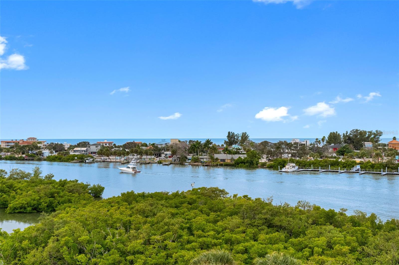 IT’S ALL ABOUT THE VIEW in this direct Intracoastal unit with fabulous Intercoastal & Gulf Views of blue and green as far as the eye can see! This 1225 sf 2 bed 2 bath condo is just waiting for a new owner!  Living/Dining room combo with wet bar, LED lighting and wood flooring throughout offering amazing water views. Kitchen is a chef’s delight with extensive custom wood cabinetry, granite countertops, breakfast bar and best of all…Intracoastal and Gulf Views.   Primary Ensuite with walk-in closet and double sink granite vanity bath sits directly on the Intracoastal with incredible views and balcony access. 2nd Bedroom is perfect for guests with walk in closet and direct second bath access. 2nd Bath is updated with granite, glass vessel sink and walk in shower. Washer & Dryer located in utility closet in kitchen.  Condo conveys with storm shutters, 1 underbuilding assigned parking spot and 1 assigned 8x8 storage room.  Shipwatch One is located in the Shipwatch 54 acre gated community with secured lobby access, plenty of guest parking and has a 2025 new roof. 2 small pets allowed 25 lbs.max. Shipwatch Yacht & Tennis Club (located just off Indian Rocks Beach) is a wonderful full-service waterfront private resort/complex on 54 lush acres with 2 pools and 2 clubhouses – one with full kitchen services & waterfront deck. Shipwatch offers 45-slip private marina(subject to availability) with guest parking, electricity, water and all the ice you need. Walking trails, exercise room, hot tubs, saunas, and 11 of the best Har-Tru clay tennis courts in the county with pro shop, viewing stands (tennis pro on staff) and massage therapist. Pickleball hardcourts are also available to owners. Lounge by the Olympic-size waterfront pool, exercise in the fitness center or heated lap pool or enjoy the sunsets from your living room, balcony, kitchen or primary bedroom. The sunsets and nature can also be enjoyed on any of the numerous walking and bike trail locations throughout the 54 acre development. Great relocation condominium especially for tennis or pickleball buffs, boaters or beach folks. Walking distance to the white sugar sand Indian Rocks Beach. Close to nightlife, shopping, post office, banking, dining, and so much more. TPA airport 40mins PIE airport 30min. It just doesn’t get any better than this…call today.  Floorplan photo#42