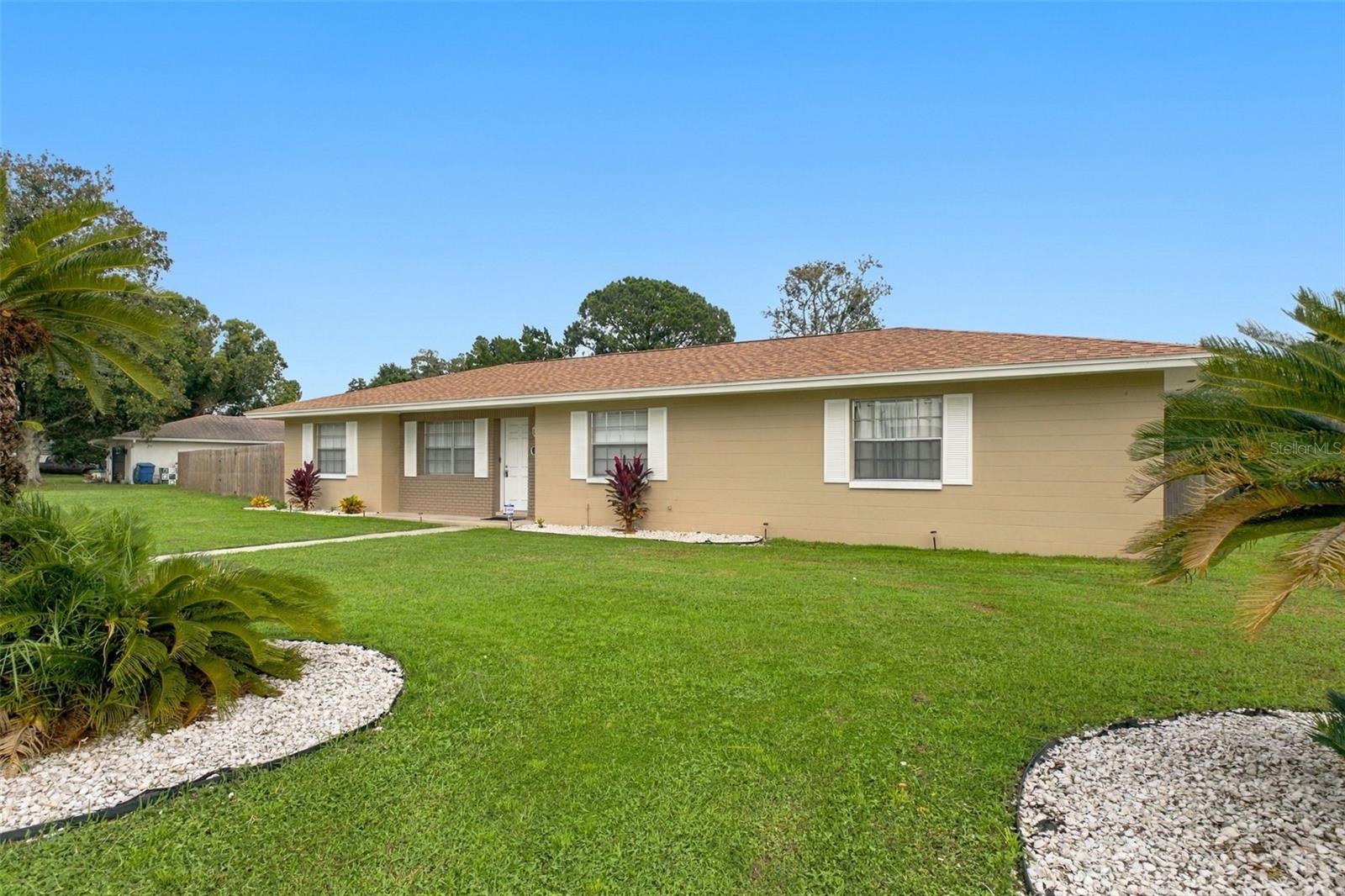 Renovated inside and out in 2025, this Spring Hill pool home combines an updated kitchen and bathrooms with a new roof, AC, water heater, electrical panel, washer and dryer, fence, and shed. Beyond the improvements, a screened pool and expansive covered lanai offer a setting you’ll look forward to enjoying every day—from afternoon swims to shaded relaxation and poolside dinners.  The connected living and dining spaces open to a kitchen featuring new white cabinetry, granite countertops, and stainless-steel appliances. Wood-look flooring and neutral finishes bring a cohesive feel throughout, while dining-area sliding doors frame views of the pool and make serving meals on the lanai easy.The two-bedroom, two-bath split layout places the bedrooms on opposite sides of the main living space, providing welcome separation for guests or a home office. The primary bedroom includes a private bathroom and walk-in closet, while the second bathroom conveniently serves visitors and the additional bedroom. Both bathrooms bring a spa-like touch to everyday routines, with beautifully tiled surrounds, mosaic accents, and shower panels featuring rain-style showerheads, body jets, and handheld sprayers. A separate indoor laundry room connects the kitchen to the two-car garage.Outside, the fenced backyard offers plenty of lawn for gardening, outdoor games, or pets. Both the fence and storage shed were installed in 2025 and are in excellent condition, adding privacy and useful storage with years of enjoyment ahead. The shed provides space for tools and yard equipment, leaving more garage room for vehicles and hobbies. A corner-lot setting with driveway access from the side street adds everyday convenience.