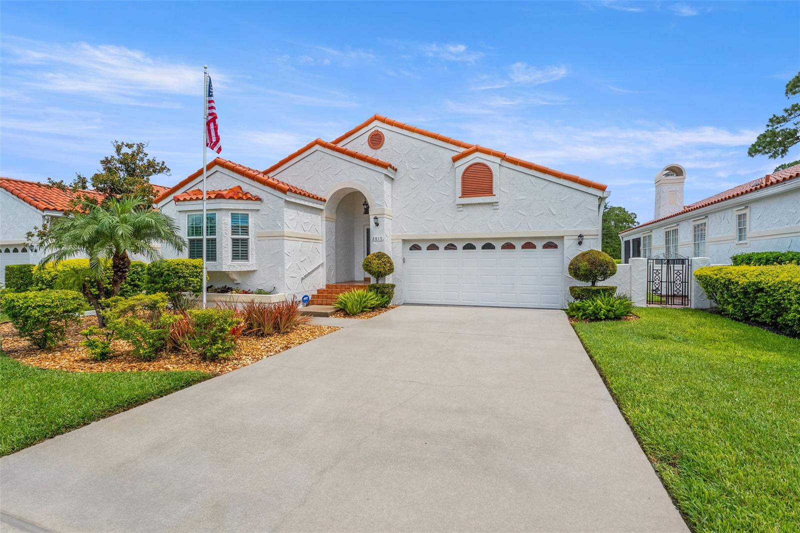 Elegant Mediterranean Sanctuary in Clearwater’s Prestigious Vizcaya Community. Discover timeless elegance in this stunning 3-bedroom, 3-bathroom Spanish Mediterranean residence, offering 2,094 sq ft of impeccably designed living space within the sought-after, maintenance-free enclave of Vizcaya. This residence offers the ultimate blend of luxury, security, and convenience. Upon entry, soaring ceilings, rich dark wood floors, and an abundance of natural light create an immediate sense of grandeur. The open-concept design seamlessly connects the great room, kitchen, and dining areas — perfect for effortless entertaining or intimate gatherings. The chef’s kitchen is thoughtfully appointed with expansive cabinetry, granite countertops, a central island, and a wine cooler for sophisticated hosting. The serene primary suite serves as a private retreat, complete with a spa-inspired bath featuring dual vanities, a Jacuzzi-style soaking tub, separate walk-in shower, and an oversized walk-in closet. Two additional guest suites offer flexibility and privacy, one with its own en-suite bath and charming bay window, while the other is located adjacent to a third full bath and oversized storage closet with a built-in wall safe. No detail has been overlooked, with recent enhancements including: interior painting (2025), Pergo Outlast laminate flooring in bedrooms (2024), smart Champion garage door opener (2024), fireplace cap and crown (2023), fully enclosed sunroom with double-pane floor-to-ceiling windows and Senville mini-split HVAC (2023), exterior painting (2023), PGT WindGuard high-impact windows and sliders (2022), LG appliances (2019 & 2023), updated guest bathroom vanity (2019), rain gutters (2018), and a Sentricon termite protection system with annual inspections since 2017.
Additional luxuries include a cozy wood-burning fireplace, custom plantation shutters, dedicated laundry room with washer and dryer, and extensive attic storage. Residents also enjoy proximity to Feather Sound Country Club, a private club offering championship golf, tennis courts, dining, and a vibrant calendar of year-round social events — elevating the resort-style living experience.
Ideally situated just 15 minutes from Tampa International Airport, 20 minutes to St. Pete–Clearwater Airport, and 25 minutes to the world-renowned sands of Clearwater Beach. Enjoy effortless access to downtown St. Petersburg, Tampa, and an array of upscale shopping, fine dining, and vibrant entertainment. This exceptional residence blends refined elegance with modern comfort — a rare offering in one of Clearwater’s most desirable communities. Schedule your private showing today and experience the Vizcaya lifestyle.
