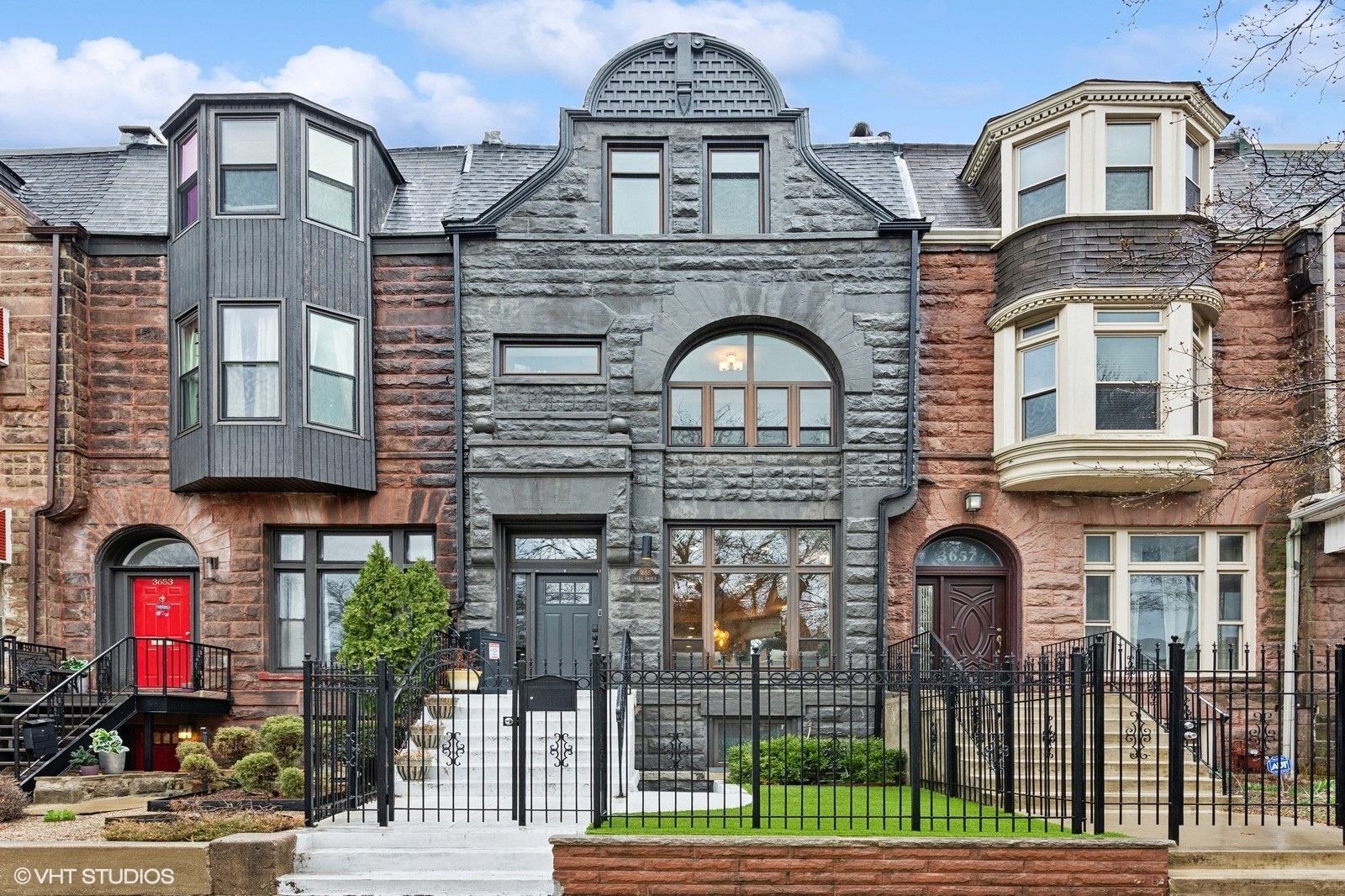 Step into timeless elegance with this newer (2018) beautifully renovated  6-bedroom, 3.5-bathroom row home, located in the heart of Bronzeville. This historic residence seamlessly blends original charm with modern sophistication, featuring stunning craftsmanship throughout-from richly stained oak floors to upgraded electrical, plumbing, and HVAC systems. The chef's kitchen is an entertainer's dream, boasting an oversized island, double dishwashers, high-end stainless steel appliances, lighted cabinetry, and a dedicated dining area-ideal for hosting gatherings large or small. Marble tile and herringbone inlay adorn all full bathrooms, each with oversized showers and elevated finishes. Sunlight pours through expansive windows, including a dramatic arched window on the second level that adds architectural flair. The third-floor primary suite offers a private retreat with French doors, a large walk-in closet, and a luxurious spa bath complete with a freestanding soaking tub and dual vanities-plus access to the roof deck (added by sellers) for your morning coffee or evening unwind. Additional highlights include tray ceilings, designer lighting, 2-panel doors with premium hardware, and a 2018-built garage. A rare find with space, style, and history in one of Chicago's most vibrant neighborhoods.