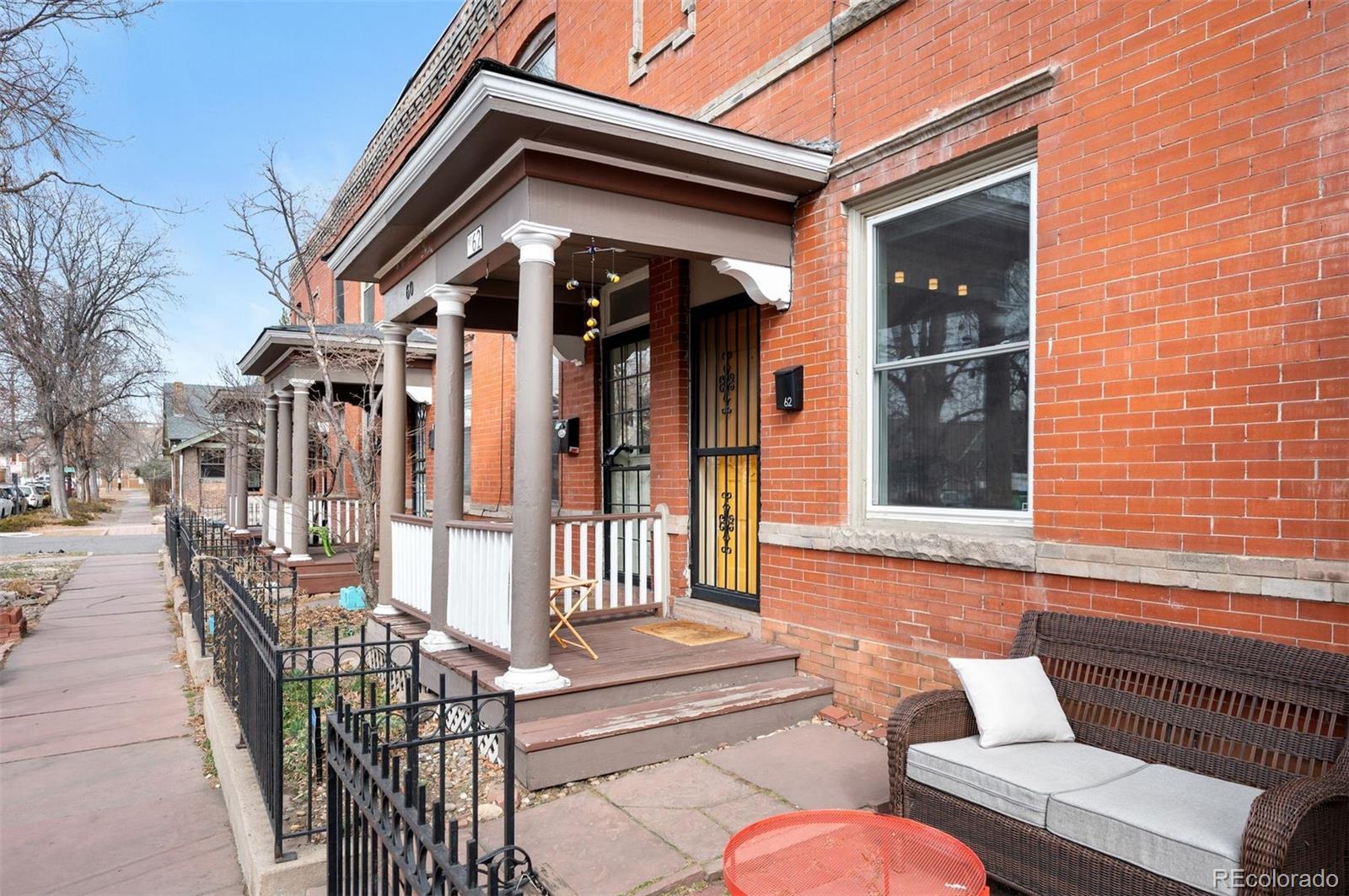 Own a classic brick row home in Denver’s Historic Baker Neighborhood! Perfectly positioned just two blocks from South Broadway’s coffee shops, boutiques, bars and restaurants.This home blends turn-of-the-century character with everyday livability. Walking into the home you're greeted by charming hardwood floors and an open living space. Lounge in the spacious living room or whip up a meal in the modern kitchen complete with built-in dining space.Upstairs, the primary bedroom fits a king bed and the second bedroom offers flexibility for a guest room, home office, or creative space. The spiral staircase adds architectural personality, while the enclosed back porch provides valuable storage and easy access to your private, fenced patio, perfect for grilling, container gardening, or letting a pup enjoy the outdoors.No HOA. No shared high-rise hallways. Just classic Denver architecture in one of the city’s most walkable neighborhoods with Dailey Park just a block away and transit nearby.If you’ve been waiting for a low-maintenance home that puts you in the middle of the action, this is it!