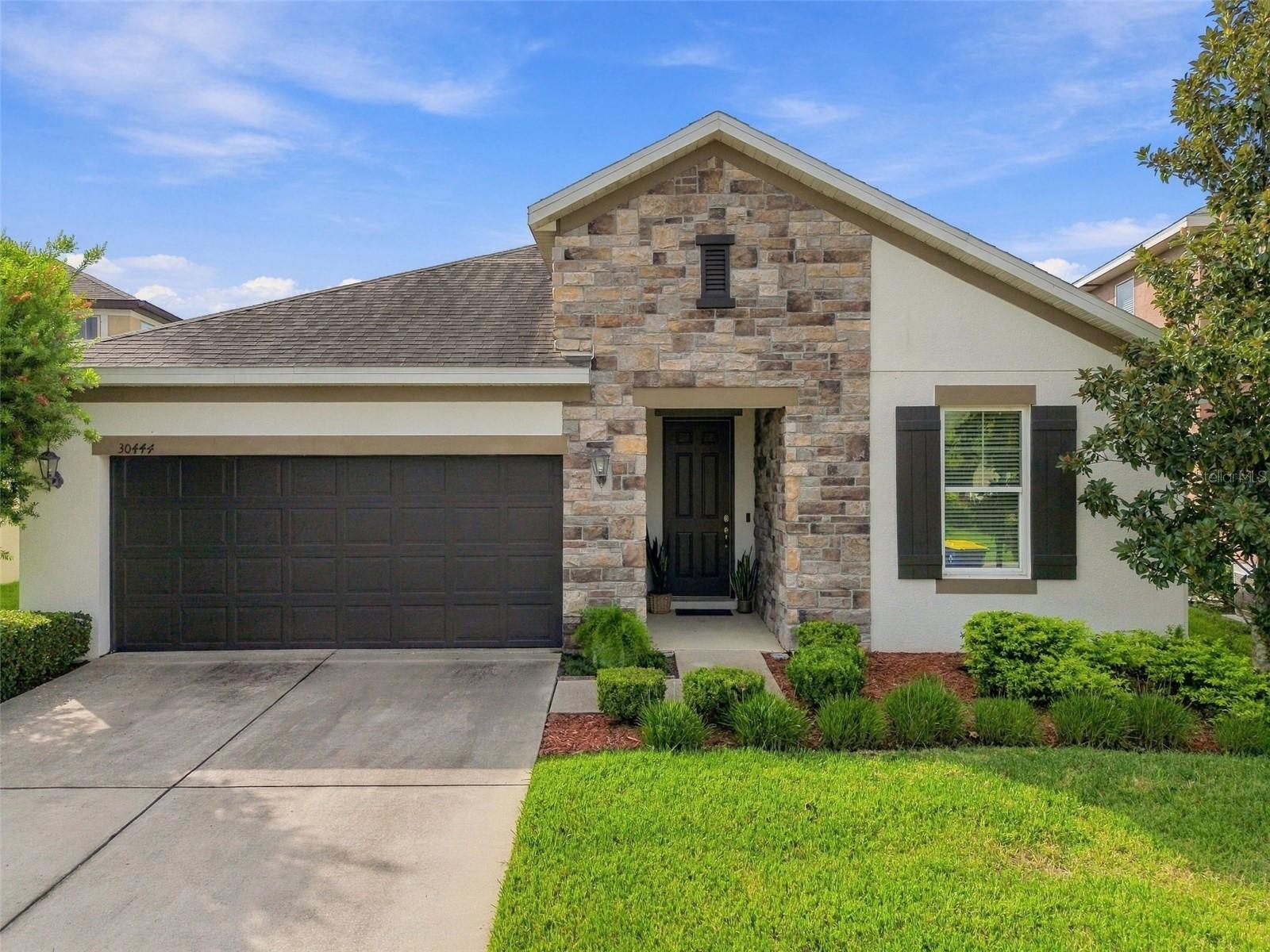 Welcome to 30444 Pecan Valley Loop! Meticulously cared for and ideally positioned with a peaceful conservation view, this spacious 4-bedroom, 3-bath home with a bonus room offers an inviting blend of comfort, functionality, and style in the highly sought after community of Country Walk. A brand-new HVAC system is being installed, providing an important peace-of-mind update for the next owner. From the moment you enter, you’ll appreciate the high ceilings, abundance of natural light, crown molding, tray ceilings, and other architectural details throughout the home. The open kitchen features granite countertops, 42-inch solid wood cabinetry, stainless steel appliances, a center island with breakfast bar, and a convenient eat-in space. The spacious primary suite is privately located at the rear of the home and features an en-suite bath with dual vanities and walk-in closets. Three additional generously sized bedrooms are located toward the front of the home, providing a desirable split-bedroom layout. The bonus room offers endless possibilities and can easily be used as a home office, playroom, gym, or additional flex space. Beautiful wood-look tile flows throughout the main living areas, with carpet in the bedrooms. Sliding doors lead to a large screened-in lanai overlooking the expansive backyard and tranquil conservation area, creating a wonderful space to relax or entertain. Built-in speakers in the living room and lanai add to the home's appeal, while the entire home is wired for an alarm system and features a Ring doorbell. Country Walk offers an exceptional array of amenities, including two community pools, tennis courts, a fitness center, playgrounds, pickleball court and more. Adding even more value and convenience, the HOA includes cable and internet, helping simplify monthly household expenses while providing residents with connected community living. Conveniently located near shopping, dining, entertainment, schools, and major roadways, with easy access to everything Wesley Chapel has to offer. This exceptional home offers the opportunity to enjoy Florida living at its finest. Schedule your private showing today!