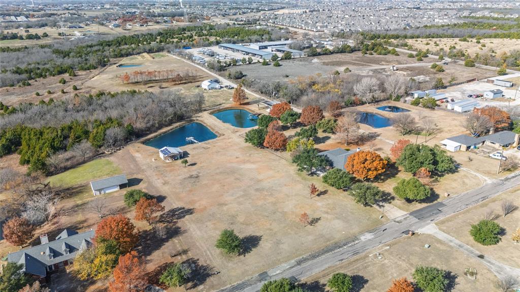 A rare opportunity to own a large, private lot in highly sought-after Wylie ISD, offering refined country living with convenient access to Lake Lavon, Collin Park Marina, and the Trinity Trails.  Located in an intimate cultural-de-sac subdivision with no HOA, this property delivers exclusivity, space and freedom.  The manicured lot features a private pond with a pump for lawn watering.  An enclosed shop adds exceptional versitility-ideal for hobbies, lake toys, workshop use, or additional storage.  Just minutes from Wylie, Lucas and St. Paul.