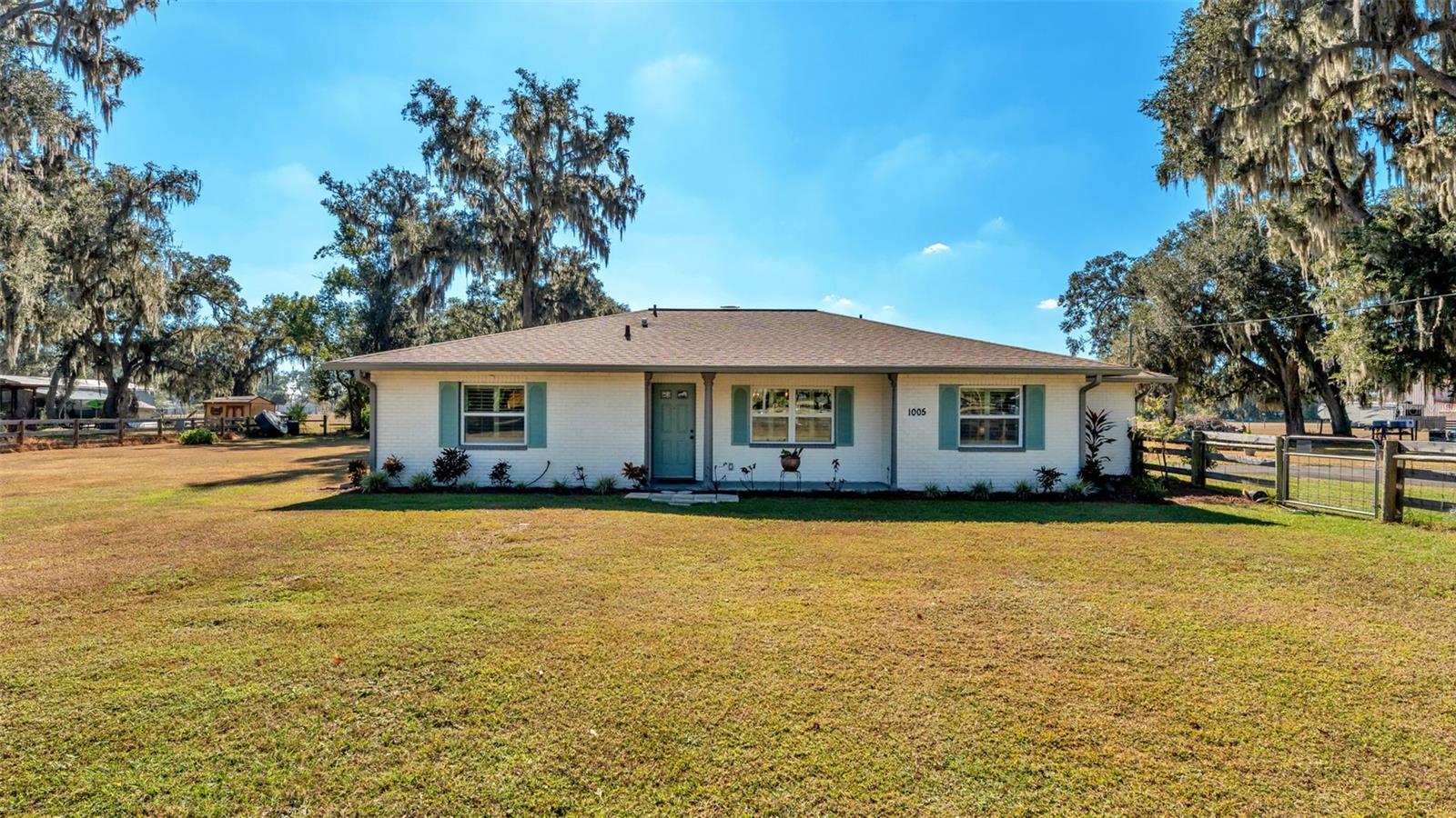 Welcome to a full acre of peaceful country living in Plant City!This beautifully updated 2-bedroom, 2-bathroom home features a versatile flex room—perfect for an office, playroom, or additional living space. Offering 1,449 sq. ft. of living area, the home was built in 1981 and thoughtfully updated with major improvements completed between 2020 and 2025.Highlights include the roof replaced in 2020, water heater replaced in 2022, all new insulation in January 2023, rain gutters added in 2024, HVAC and ductwork installed in 2023, and a brand-new asphalt driveway finished in 2025.Inside, you’ll find laminate flooring in the main living areas, carpeted bedrooms, and a cozy wood-burning fireplace. Additional interior features include hurricane-impact windows, plantation shutters, and a spacious laundry room located just off the kitchen.Step out to the screened back patio and enjoy peaceful views of the pasture. The fully fenced yard sits within the surveyed boundaries, with the option to expand if desired. The property also offers a variety of mature plants such as avocado, cranberry hibiscus, ginger, shampoo ginger, aloe, and moringa (Tree of Life). This property allows for animals such as chickens, pigs, and goats.Additional features include two attached garages—one of which can serve as a workshop—each with its own entry point and remotes. A generator plug-in connection is located under the main panel. Best of all, there’s no HOA.Conveniently located about 40 minutes to Tampa, 1 hour and 20 minutes to Orlando, and approximately 18 minutes to the Florida Strawberry Festival. The seller is flexible and willing to accommodate a closing date that works best for the buyer.