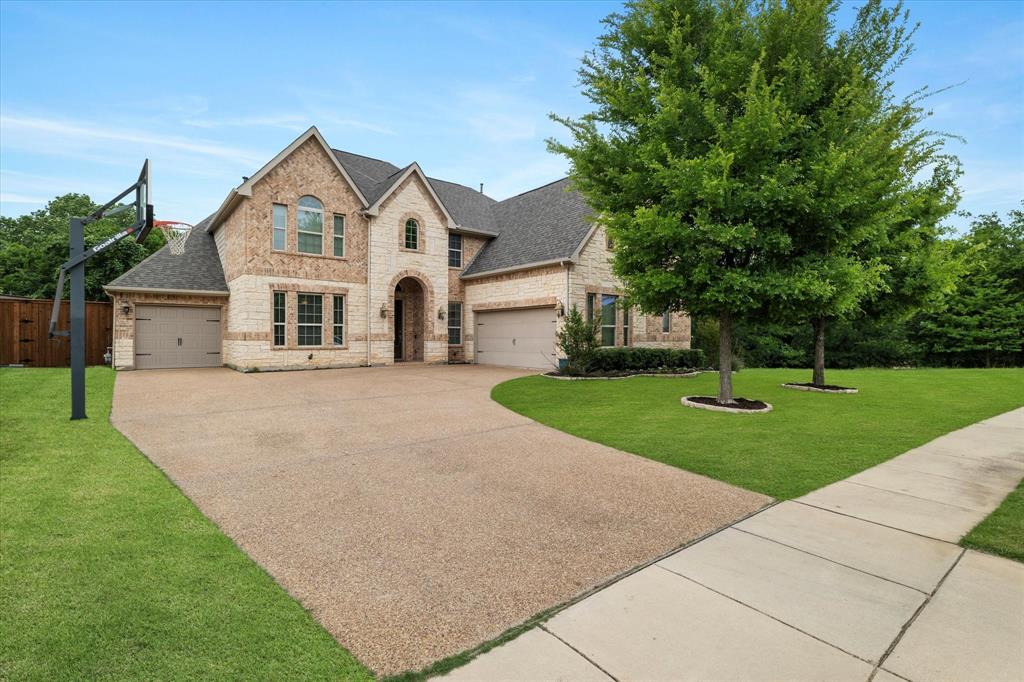 Welcome to this thoughtfully designed Trophy Club home, perfectly positioned along the peaceful Corps of Engineers trail. This highly sought-after Next Gen floor plan is ideal for multigenerational living, offering a private attached suite complete with its own entrance, kitchen, living room, bedroom, bathroom, laundry area, and garage, providing both independence and connection for your loved ones.

Step inside the main home and be greeted by soaring ceilings and rich wood floors. The open-concept layout features a spacious kitchen with granite countertops, stainless steel appliances, and an oversized pantry - perfect for entertaining and everyday living. The double-height living room boasts a striking stone fireplace, adding warmth and elegance to the space.

A beautifully crafted office with custom woodwork offers a quiet retreat, while the primary suite provides a relaxing haven with a generous walk-in closet. Upstairs, you’ll find a large game room-living area, two sizable bedrooms with a Jack-and-Jill bathroom, and a media room, perfect for movie nights at home.

Step outside to your luxury covered patio, complete with an outdoor kitchen and fireplace, where you can enjoy serene views of the Corps trail and the natural surroundings.

Additional highlights include a brand-new roof installed in April 2025. Don’t miss this incredible opportunity. Schedule your private showing today!