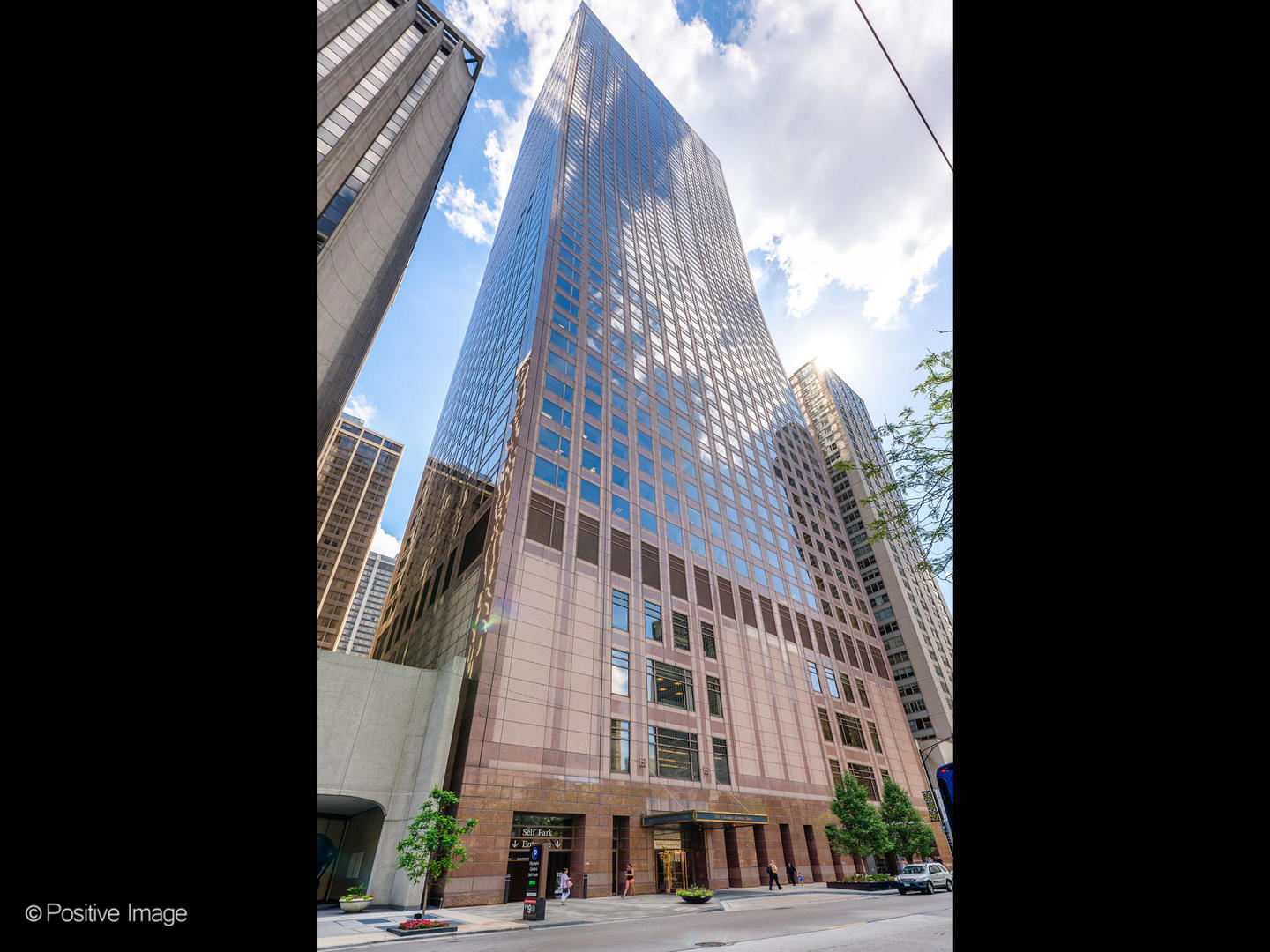 Set high above the Magnificent Mile in the esteemed Olympia Centre, this beautifully appointed corner residence offers generous proportions, thoughtful design, and sweeping southeastern views of the lake and skyline. A gracious entry with marble flooring opens to a large-scale living and dining space filled with natural light from wraparound windows, creating an ideal setting for everyday living and entertaining. The kitchen is bright and elegant with marble floors, a custom bar, and a breakfast area overlooking the city. The intelligently designed split floorplan offers exceptional privacy, with an expansive primary suite featuring space for a sitting area or home office, two large walk-in closets, and a marble bath with soaking tub and separate shower. The secondary bedroom is equally spacious with its own recently renovated en-suite bath. A powder room, full laundry and storage room, and custom details throughout complete the interior. Residents enjoy the full-service lifestyle that makes the Olympia Centre so desirable, with 24-hour door staff, concierge, an indoor pool, shared roof deck and fitness center, all in a prime location just moments from the lakefront, renowned museums, and Chicago's most iconic restaurants and shopping. On-site garage parking available.