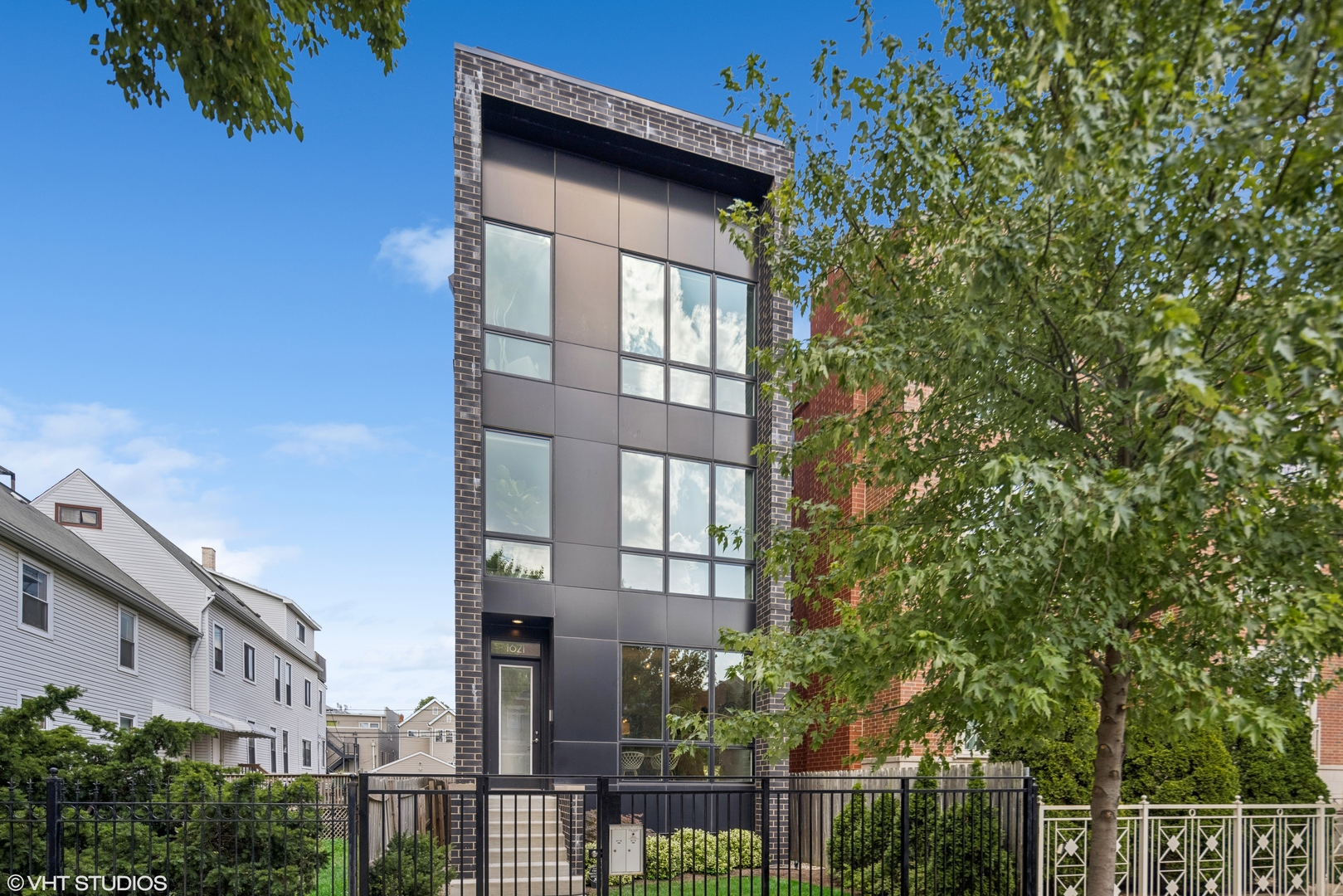 With Walk and Bike Scores of 90+, this contemporary duplex is just steps from Bucktown, Humboldt Park, and Wicker Park, less than two blocks to the Bloomingdale Trail, and 0.5 miles to the Western Blue Line. Carefully designed to feel like a single-family home, the main level features formal living and dining areas that lead to a two-tone kitchen with custom flat-panel cabinets, Bosch appliances, a large island with quartz waterfall countertops, and a walk-in pantry. The kitchen connects to a powder room and a family room, opening onto a deck and a lush, landscaped yard. The heated lower level includes a king-sized primary suite with a steam shower, body sprays, dual vanities, and a walk-in closet, along with two additional spacious bedrooms and a full laundry room. Additional features include a vented gas fireplace, an Ecobee smart thermostat, a Comelit video doorbell, and a whole-home humidifier. Choose up to one of 5 outdoor spaces including front and back landscaped yards, two decks, and roof rights above the garage for your private rooftop deck. One garage parking space is included.