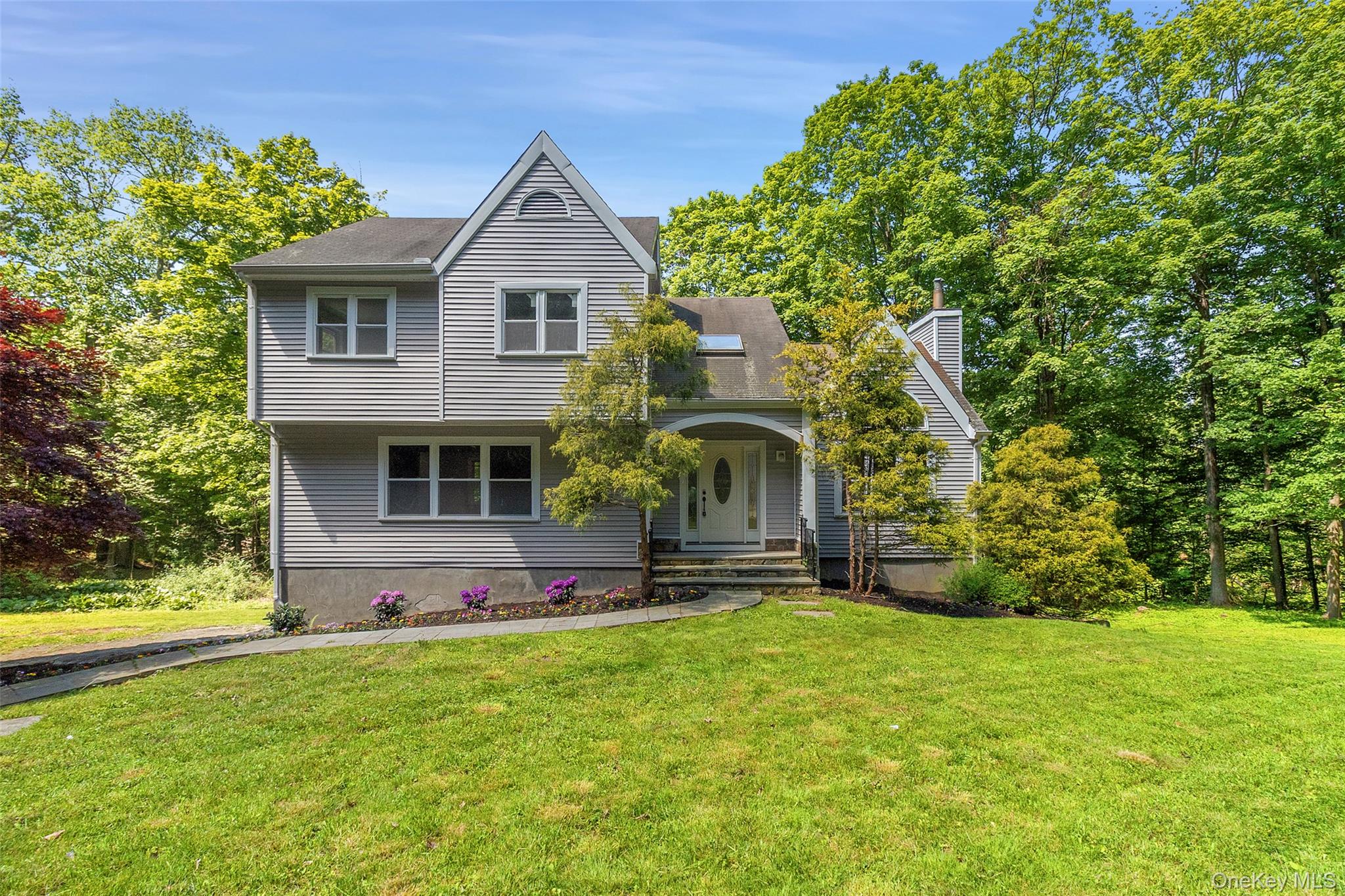 Beautifully updated and move-in ready, this 4-bedroom home is set on 2 private acres in the highly desirable Katonah-Lewisboro School District. Thoughtfully renovated throughout, the home features refinished hardwood floors, fresh neutral interiors, brand-new stainless steel appliances, 2 full bathrooms, and an updated powder room.The light-filled open layout offers comfortable everyday living and effortless entertaining. The updated kitchen showcases white shaker cabinetry, modern finishes, and seamless flow into the dining and living spaces. A dramatic vaulted-ceiling living room with fireplace creates a warm and inviting centerpiece, while spacious bedrooms provide flexibility for family, guests, or home office needs.The lower level offers additional flexible living space perfect for a playroom, gym, media room, office, or guest area. Surrounded by peaceful natural scenery, this turnkey South Salem home combines privacy, style, and convenience just minutes from town, schools, parks, and major commuting routes.