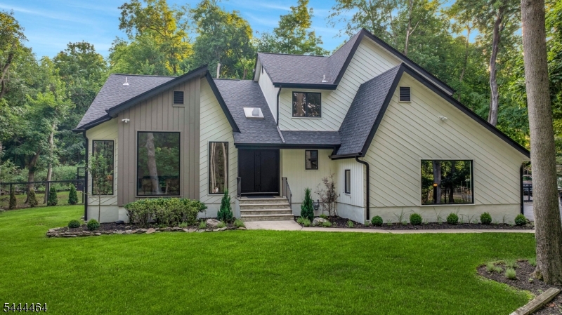 Tucked at the end of a quiet cul-de-sac and set down a long private driveway, this fully reimagined contemporary residence offers privacy and luxury. Set on over 0.85 acres of beautifully landscaped, park-like property, this exceptional home blends peaceful living with refined design and everyday convenience. Offering 2 leves of apprx 3,124 sqft plus a 1,300 sq t finished lower level, the home is filled with natural light from expansive windows and multiple skylights. A dramatic double-height foyer opens to an elegant layout designed for both comfortable living & entertaining. The chef's kitchen features TajMahal quartzite countertops and backsplash, a waterfall center island, Bertazzoni induction cooktop, two Bertazzoni refrigerators, Bertazzoni dishwasher, walk-in pantry, and abundant storage. It flows seamlessly into the dining area and inviting family room with fireplace. Upstairs are four spacious bedrooms, including a luxurious primary suite with a custom walk-in closet and spa-like bath. The finished lower level offers a large rec room, flex space, full bath, and storage. Highlights include renovated kitchen and baths, 3-zone central air, new roof, and 7.5-inch engineered wood flooring. Expansive deck overlooking serene, park-like grounds. A rare find in Haworth, this home combines contemporary architecture, luxury finishes, exceptional privacy, and close proximity to top-rated schools, premier shopping, dining, and New York.