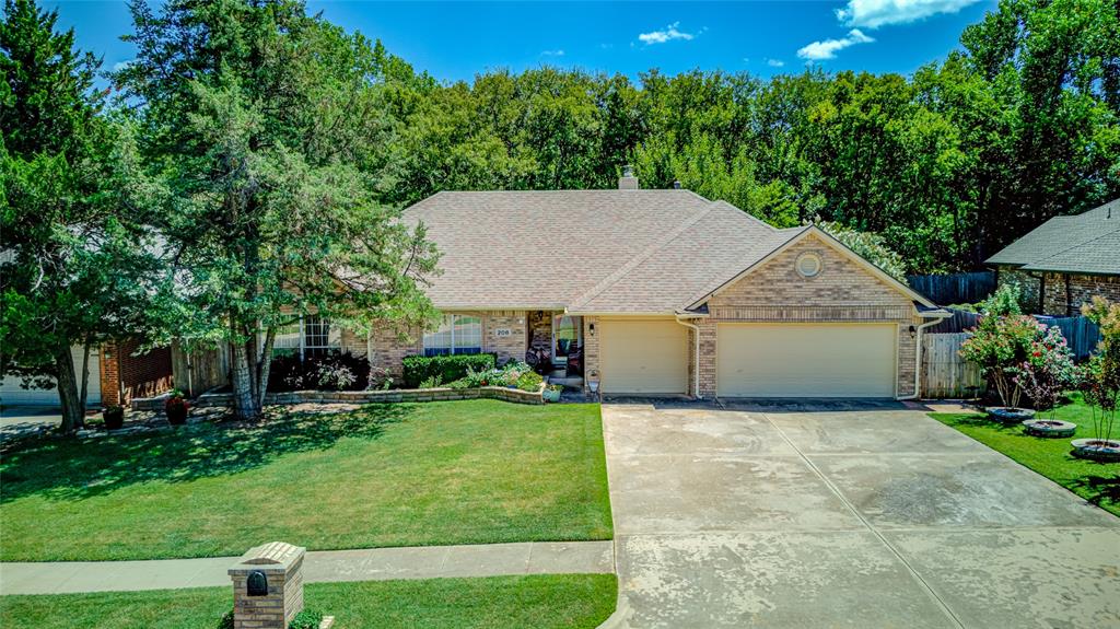 THIS HOME HAS IT ALL!! Builder's show home in its time. These sellers have kept it immaculate and added WONDERFUL updates throughout this open floor plan.  Ceramic wood-look floor throughout the entire home.  Lots of beautiful detailed woodwork, from crown molding to bookcases, from cased wood around the fireplace and cased wood accenting the kitchen.  Updated with designer tile on fireplace, also added a beautiful hearth. Designer tile on kitchen backsplash.  Granite in the kitchen with a large breakfast bar.   
This kitchen is perfect for cooking, and family gatherings.  Split bedroom plan.  Primary bathroom is huge and has stunning tile and separate jetted tub.  Great primary closet.   Wait until you see the backyard.  It backs to a natural creek with trees and southern exposure.  Sellers have added tons of beautiful landscaping both front and back.   Large covered patio, peaceful koi pond, lots of flower beds and nice garden spot. Feels like a little piece of paradise.  Extra large patio holds a large table and chairs.  Separate building to store all your yard equipment and gardening tools.  Roof and AC recently updated.  3 car garage.  Easy access to Tinker AFB, OKC, Downtown Norman Arts and restaurants, University of Oklahoma.  Move in Condition.