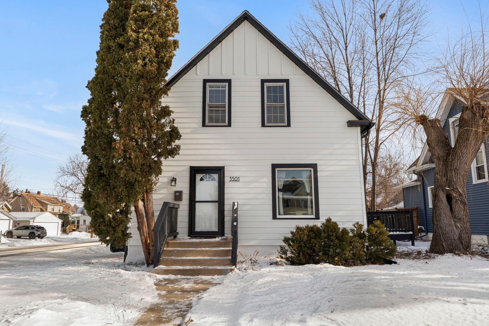 Welcome to this charming three-bedroom, two-bathroom home in a quiet neighborhood, blending historic character with modern updates. Spacious foyer with hardwood floors leads to a light-filled living room with large windows. The remodeled kitchen (2022) features Samsung stainless steel appliances, black cabinetry with under-cabinet lighting, tile backsplash, ample counter space, and luxury plank flooring. Enjoy morning coffee in the 10x6 screened porch, which opens to a large fenced backyard and deck—perfect for entertaining. The dining room includes hardwood floors, a modern chandelier, a storage closet, and French doors to the deck. Upper level offers three bedrooms; primary bedroom has new carpeting, a walk-in closet, and a balcony overlooking the backyard. Bedrooms two and three include walk-in closets and feature new carpeting or hardwood flooring. Updated full bathroom with tile flooring and tiled tub surround. Recent updates include sewer drain lining (2014), James Hardie siding and new gutters (2023), upgraded electrical panel with grounding (2023), spray cellulose insulation (2023), and professional lawn treatments (2025). Don’t miss this home with numerous modern updates throughout.