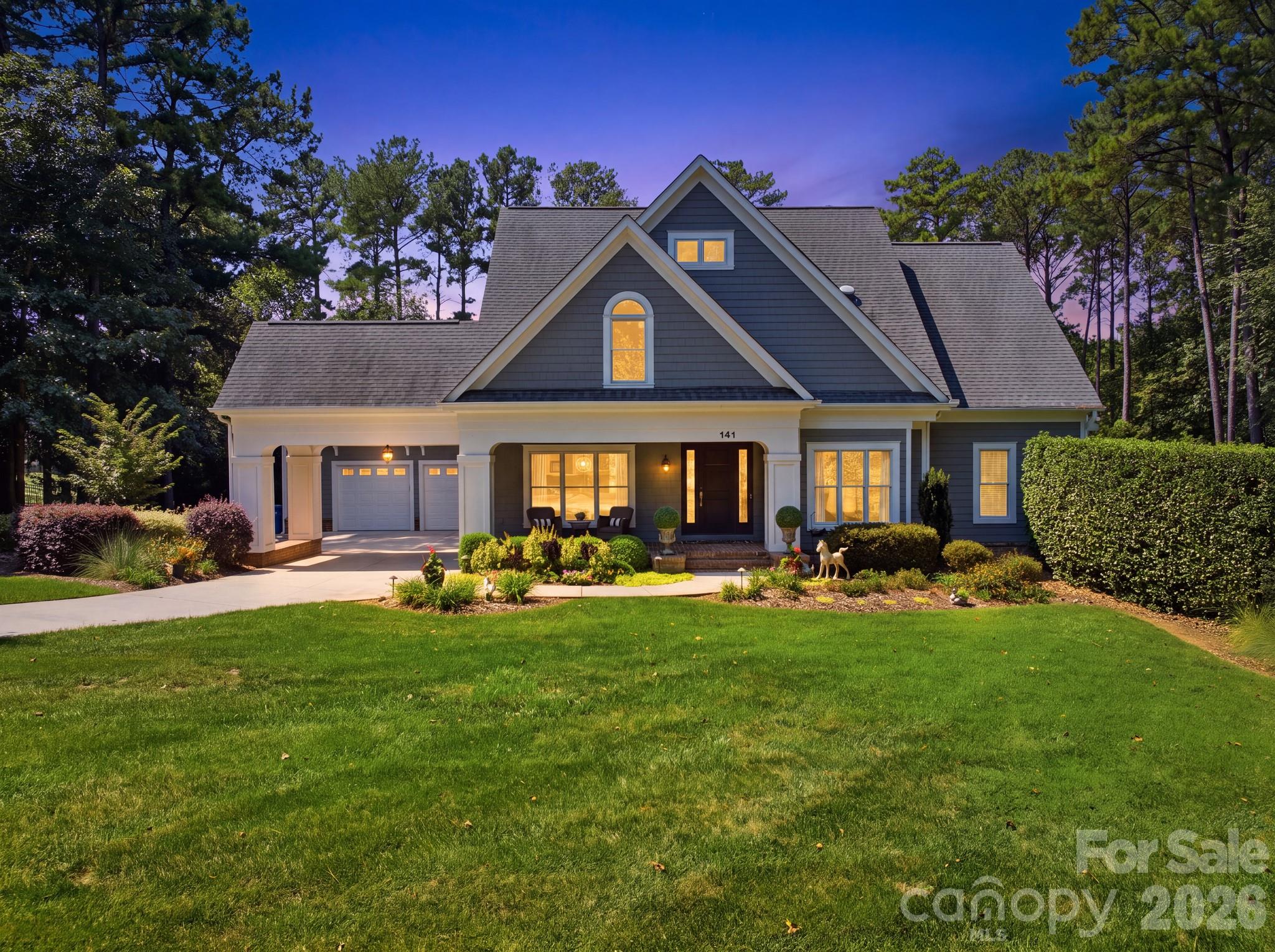 141 Stonewall Beach offers more than an exceptional home.. it delivers the coveted Lake Norman lifestyle within The Point, Mooresville’s premier golf and waterfront community. Set along the 11th tee of Trump National Golf Club Charlotte, this custom residence pairs resort-style living at home with Lake Norman just feet away. Spend mornings overlooking the golf course, afternoons enjoying the saltwater pool, tanning ledge, and private multi-sport recreation court, then take a short walk or golf cart ride to your deeded boat slip for a sunset cruise on on the lake. The Point surrounds residents with miles of Lake Norman shoreline, walking trails, the Village Green and a vibrant private club setting featuring dining and social experiences, with additional golf, racquet, fitness, pool and spa amenities available based on membership level.Inside, abundant natural light, rich architectural detail and curated finishes complement expansive golf course views. The great room features a stacked-stone fireplace and custom built-ins, while the chef’s kitchen offers quartz surfaces, an oversized island, wine refrigerator and adjoining breakfast and sitting area. The main-level primary suite provides a private retreat with a tray ceiling and spa-inspired bath. Upstairs, three additional bedrooms, two full baths and a generous bonus room offer exceptional flexibility.Privately positioned on a corner lot yet connected to everything that makes The Point special, this is a home designed around the way people come to Lake Norman to live—golf, boating, entertaining and effortless indoor-outdoor living, all within convenient reach of Mooresville, Davidson, Cornelius and I-77.