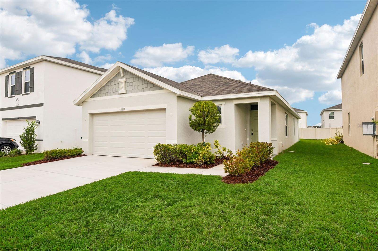 Virtually Staged. Exceptional value in the heart of Wesley Chapel! Built in 2024 and move-in ready, this beautifully maintained one-story home offers the perfect combination of newer construction, modern finishes, desirable community amenities and a convenient Wesley Chapel location. Light, bright and thoughtfully designed, the home features a neutral color palette, an open floor plan and tile flooring throughout the main living areas. Separate living and dining spaces provide flexibility, while the split-bedroom layout offers privacy and functionality.The well-appointed kitchen features quartz countertops, stainless steel appliances and a convenient breakfast bar overlooking the main living area. The spacious primary suite includes a large walk-in closet, while contemporary rectangular sinks add a modern touch to the bathrooms. A washer and dryer are also included for added convenience.Outside, the generous backyard provides plenty of room to enjoy the Florida lifestyle, with a covered lanai creating an inviting space for relaxing or entertaining. Residents of Avalon Park West enjoy an impressive collection of amenities, including a clubhouse, swimming pool, splash pad, playground, dog park, walking trails and more. Conveniently located near Wesley Chapel’s extensive shopping, dining and entertainment options, with easy access to major highways, this home delivers exceptional value in one of the area’s most desirable locations.