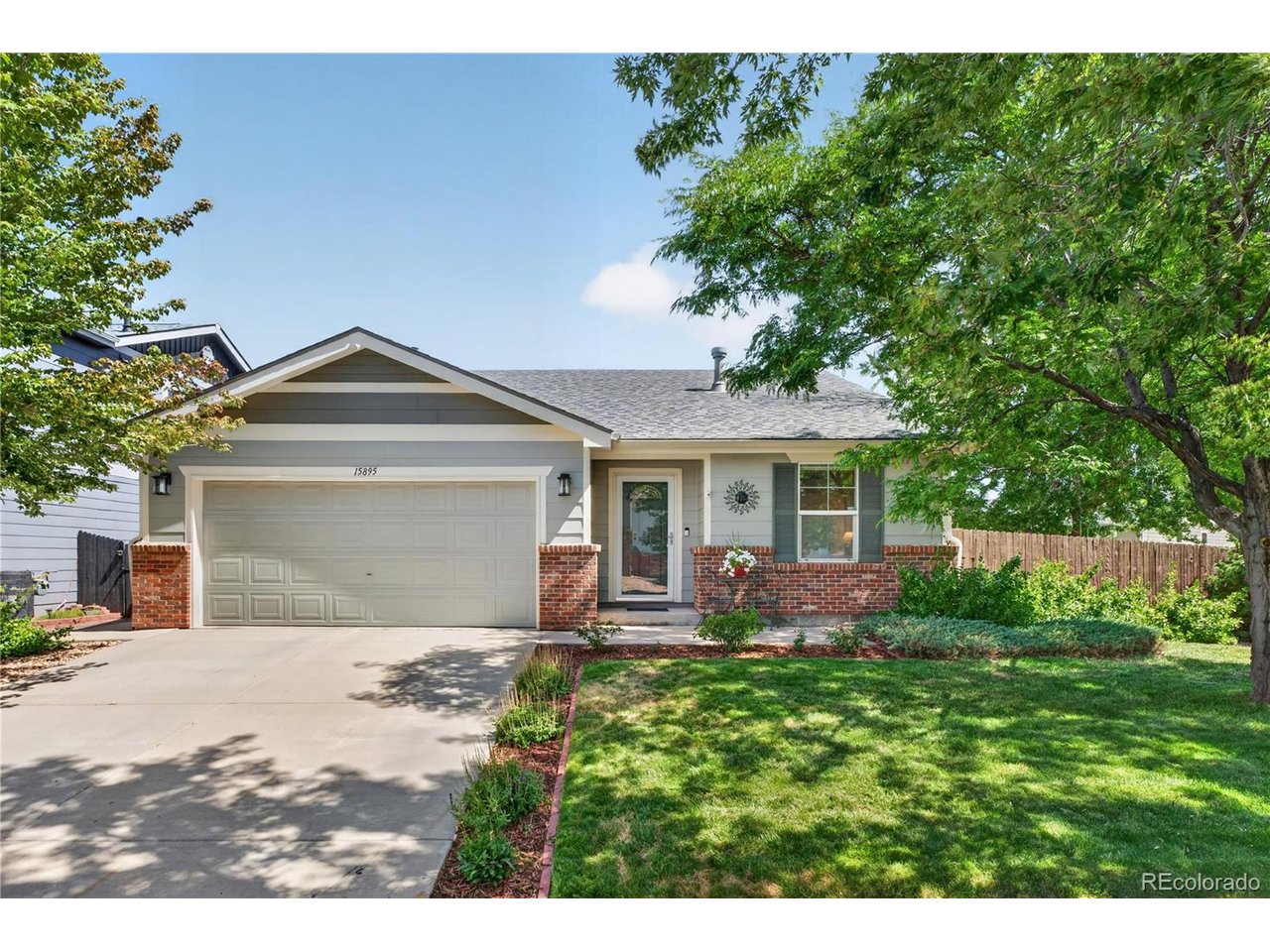 Welcome to this well-cared-for home situated on a prime corner lot in Denver's Parkfield neighborhood! Showcasing beautiful front landscaping, mature shade trees, and fantastic curb appeal, this residence offers a warm and inviting atmosphere from the moment you arrive. Step inside the entry hallway, which flows naturally into a spacious living room centered around a cozy fireplace. The layout leads into an open kitchen and dining area featuring sliding glass doors that open directly out to the back patio. The primary suite serves as a peaceful retreat, complete with its own private sliding glass door access to the patio, a walk-in closet, and a luxurious 5-piece en-suite bathroom. Two additional bedrooms and a full hallway bath offer plenty of room for family, guests, or a home office. Out back, the expansive, fully fenced backyard is a true oasis! Relax under the patio's expandable awning for afternoon shade while enjoying the lush lawn and professional landscaping. Ideally positioned close to local parks and shopping, with quick access to both DIA and Downtown Denver, this turnkey home offers exceptional convenience and comfort!