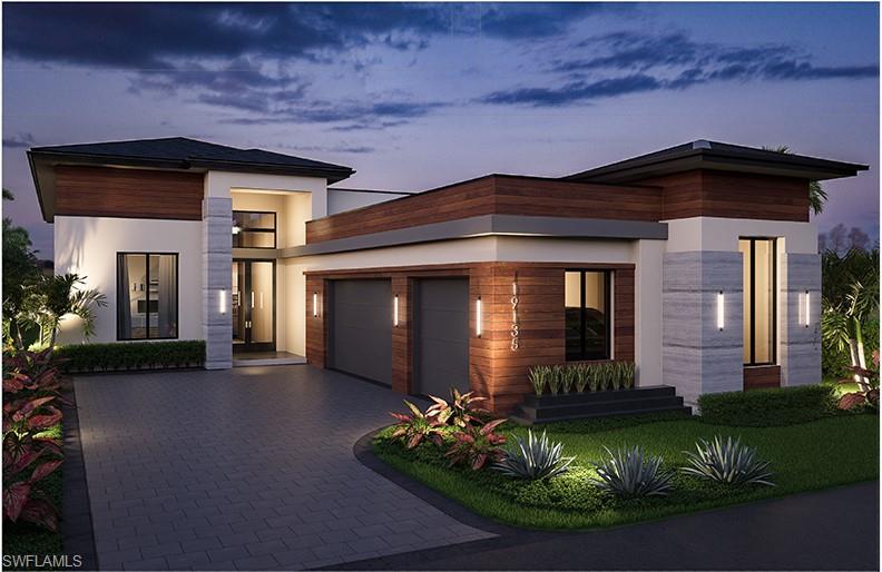 Modern home featuring an attached garage, decorative driveway, and stucco siding