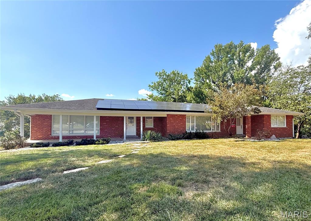 Welcome home! This meticulously maintained traditional brick home offers an incredible combination of space, thoughtful updates, and a beautiful one-acre setting in the sought-after Fort Zumwalt School District. With nearly 2,400 square feet of living area on the main level alone, this spacious home offers plenty of room to live, work, entertain, and enjoy!From the moment you step inside, you’ll appreciate the abundance of beautiful natural light pouring through the home’s large windows, creating a warm and inviting atmosphere throughout. The spacious upper level features wood laminate flooring, carpeting, a gas fireplace with custom shelving, and an updated kitchen with soft-close white cabinetry, stainless-steel appliances, a custom island, and a dedicated office space. The updated primary bathroom creates a spa-like retreat, offering a peaceful space to relax and unwind.The expansive 1,700-square-foot walkout basement provides even more space and flexibility for hobbies, work, recreation, entertaining, or additional living space. The basement also features a bedroom, workbench area, and tuck-under garage for added functionality and convenience. Step outside to enjoy the oversized patio and beautiful views of the expansive one-acre lot, with plenty of room to enjoy the surrounding nature and outdoor space. Conveniently located near shopping, restaurants, entertainment, and everyday amenities, this home offers the perfect balance of peaceful surroundings and accessibility. Don’t miss your opportunity to make it yours!