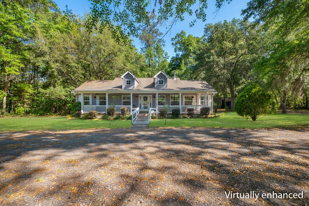 This beautiful 3 bedroom, 2.5 bath home has 1662 sq ft and sits on a full acre of land in a quiet, peaceful South Georgia setting.  Offering both space and privacy, this property is perfect for those looking to enjoy a relaxed lifestyle surrounded by nature.  Inside, you will find souring vaulted ceilings in the living and family room, creating an open and airy feeling throughout.  The spacious kitchen features Corian countertops with integrated sinks, ample cabinetry and black appliances, including a French door refrigerator.  A generous sized pantry with a stunning glass door adds both function and charm. Just off the kitchen, the dining room is filled with natural light due to numerous windows, while recessed lighting in both kitchen and dining areas enhance the home's warm and inviting atmosphere. Step outside to enjoy the large brick back porch overlooking a private wooded backyard and gazebo.  The front of the home features a full length brick porch that wraps the entire facade, adding timeless curb appeal. Additional features include a garage, covered carport and building in the rear for extra storage and workspace.  This property combines comfort, style and peaceful surroundings, don't miss your chance to call it home!