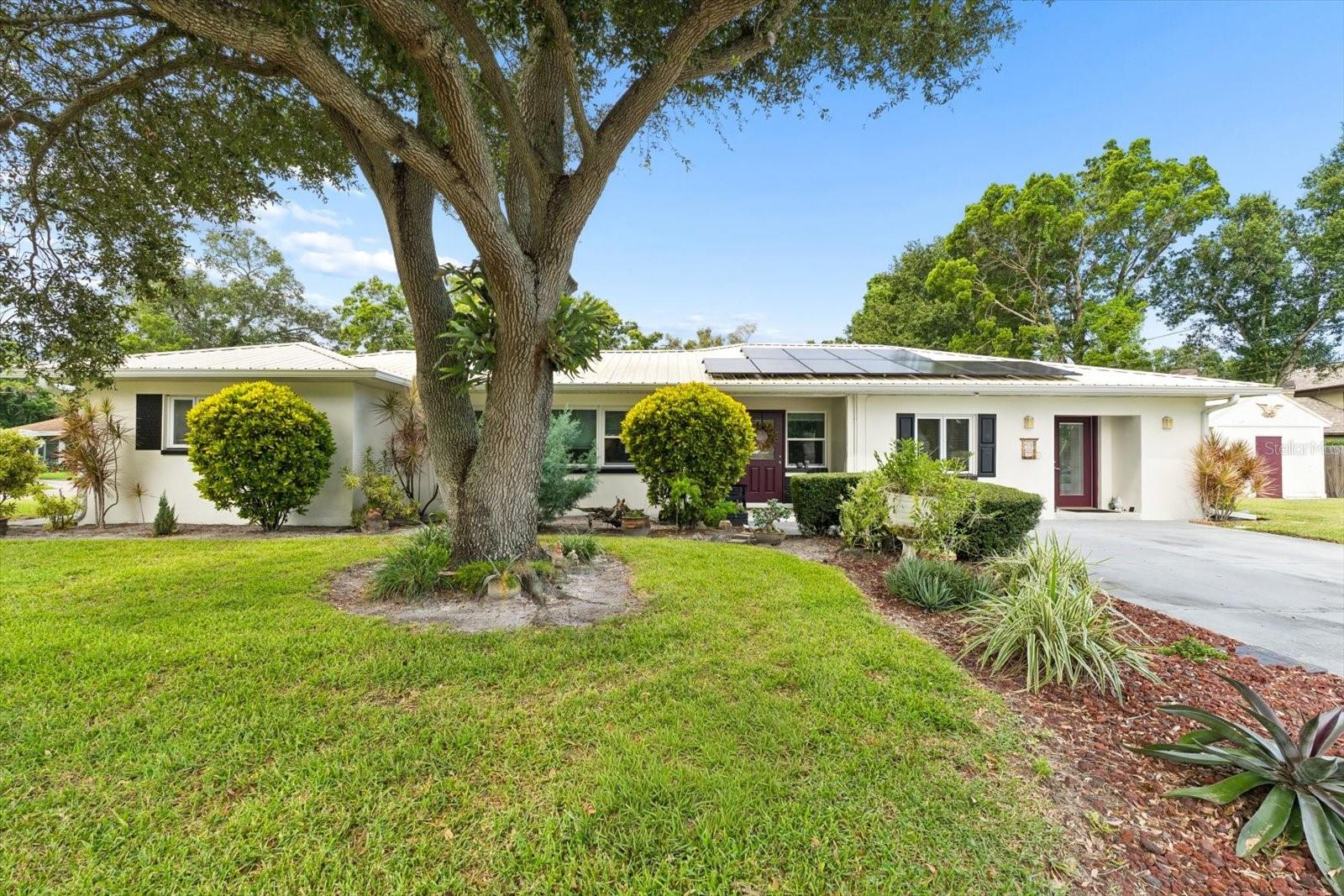 QUALIFIED BUYERS MAY BE ELIGIBLE FOR A LENDER-PAID 1/0 TEMPORARY RATE BUYDOWN! Ask for details.Welcome to a home that offers flexibility, privacy and a fantastic Clearwater lifestyle in a quiet, family-friendly neighborhood you’ll love coming home to. This unique property features a 2-bedroom, 1-bath main home PLUS a separate 1-bedroom, 1-bath in-law suite with its own private entrance. Whether you need space for extended family, guests, a home office or simply want a private space for visitors, this versatile setup offers so many possibilities.  One of the home's true highlights is the spacious screened-in back patio with a wood-burning fireplace. Imagine cool fall and winter evenings gathered around the fire with family and friends, enjoying dinner, drinks or simply relaxing in your own backyard.The home also features a durable metal roof and leased solar panels, currently costing the owner $138 per month, with approximately $42 per month paid to Duke Energy.  And then there’s the neighborhood! Peaceful, quiet and welcoming, with a park and golf course both within walking distance. It’s the kind of location where you can enjoy a little more space and tranquility while still being close to everything Clearwater has to offer.  When you're ready for a day at the beach, you're approximately 7 miles from the Gulf beaches. The local airport is also approximately 7 miles away, making travel incredibly convenient.  As an added bonus, the seller is willing to negotiate leaving the furniture, giving the next owner the opportunity for an easy transition into their new home. A versatile floor plan, private in-law suite, beautiful screened outdoor living space, wood-burning fireplace, solar, metal roof and an unbeatable neighborhood setting make this Clearwater home one you’ll want to see in person. Come take a look — you may be surprised by just how much this home has to offer!