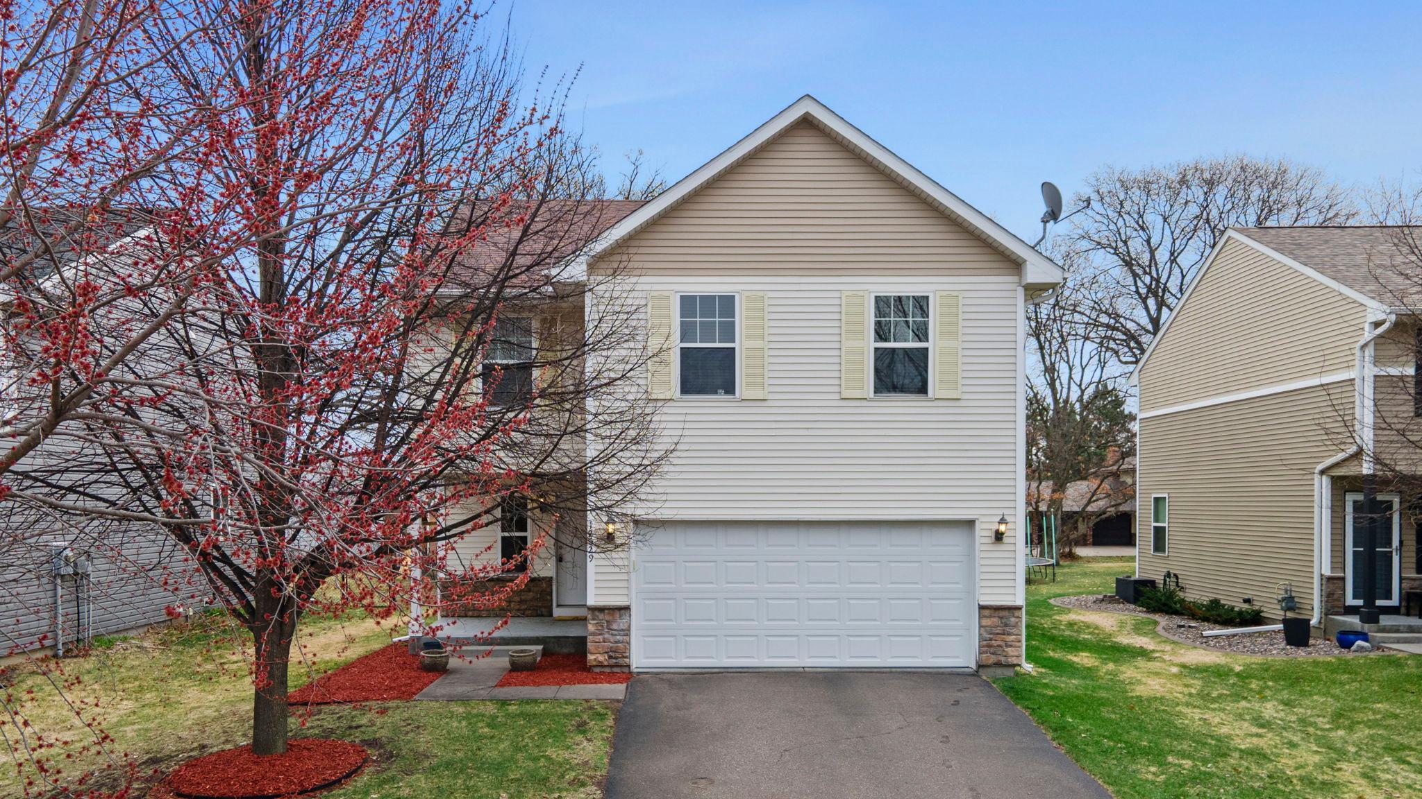 Set in a quiet, peaceful Blaine neighborhood, this 4-bedroom, 4-bath home offers an impressive blend of space, updates, and inviting indoor-outdoor living, just minutes from parks, Sunrise Elementary, Sunrise Lake, and Lakeside Commons Park—featuring a beach, playground, splash pad, and a variety of recreational amenities.Inside, the main level features an open, comfortable layout filled with natural light, highlighted by a welcoming living room with a Heat-n-Glo fireplace and scenic backyard views.The kitchen combines style and function with hardwood floors, granite countertops, sleek appliances, and abundant cabinetry, flowing seamlessly into the dining area with updated statement lighting (2026) and direct patio access.Upstairs, three spacious bedrooms include a private primary suite with a walk-in closet and bath, while a versatile loft and upper-level laundry with a GE smart washer (2023) add everyday convenience.The finished lower level (2022) expands the living space with a large family room, fourth bedroom, and nearby 3/4 bath.Outside, enjoy a covered front porch and private patio framed by mature trees. A two-car garage and new furnace (2025) add peace of mind.
