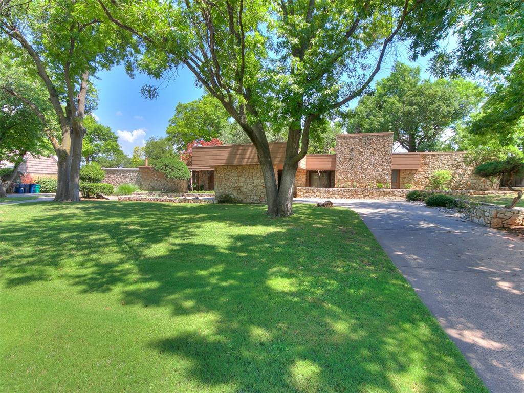 Mid-century modern dream home nestled on the golf course at the highly sought-after Quail Creek Golf & Country Club! This stunning 4-bedroom, 3.5-bathroom property combines timeless architecture with breathtaking views. Walls of windows flood the home with natural light and offer panoramic views of the pool and lush fairways—creating a serene and inspiring atmosphere throughout. The open-concept layout is perfect for entertaining, with spacious living and dining areas that flow seamlessly into the kitchen and outdoor living space. Located in the heart of Quail Creek with the added benefit of Edmond schools, this home offers the best of both worlds. Surrounded by mature trees and beautifully landscaped grounds, this is a rare opportunity to live in a truly special setting. Don't miss your chance to make this one of-a-kind home yours!