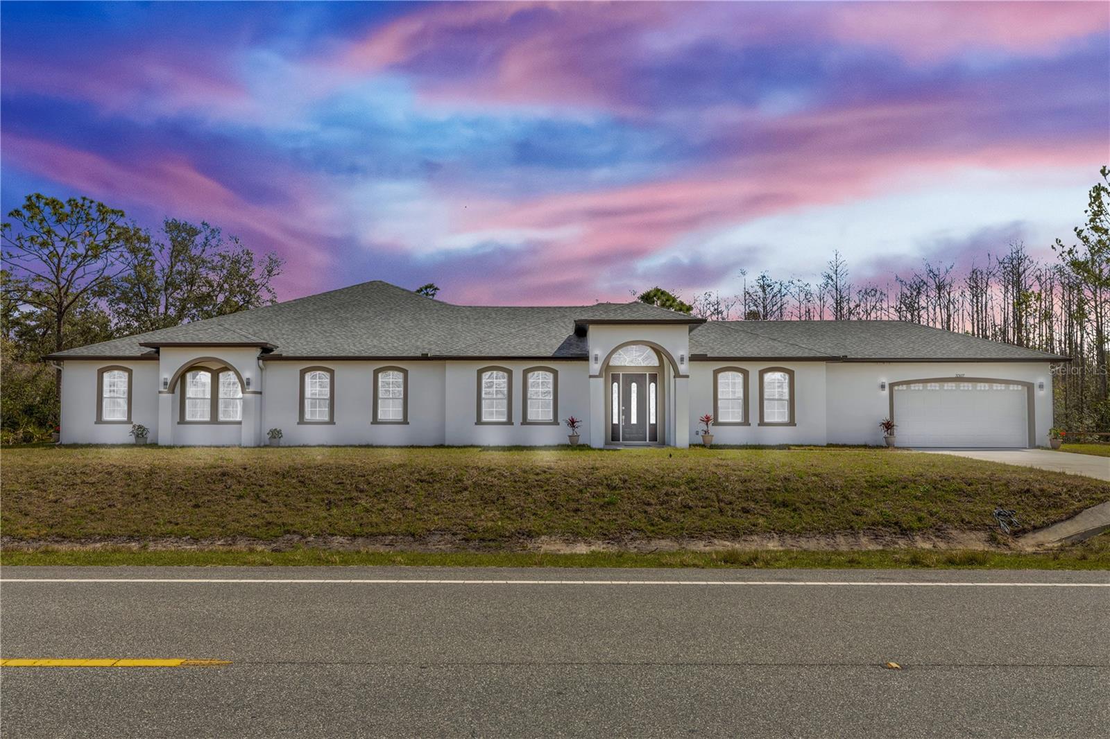 Completed in NOVEMBER 2025, this CUSTOM-BUILT ESTATE sits on 1.19 ACRES and offers over 5,200 SQUARE FEET of thoughtfully designed living space. Built to stand apart, every inch of this home reflects intentional craftsmanship, elevated design, and true pride of ownership. From the moment you walk in, you’re greeted with PORCELAIN TILE FLOORS, ABUNDANT NATURAL LIGHT, and SOARING OPEN SPACES that create an immediate sense of luxury and comfort. At the heart of the home is a SHOW-STOPPING CHEF’S KITCHEN featuring QUARTZITE SLAB COUNTERTOPS, FLOOR-TO-CEILING CUSTOM CABINETRY, and a STATEMENT TILE BACKSPLASH. Designed for both everyday living and entertaining, this space is as functional as it is unforgettable. The home offers THREE PRIVATE BEDROOM SUITES, each with WALK-IN CLOSETS and their own FULL BATHROOM, creating true retreats for family and guests. One of the most powerful features is the 1,300 SQUARE FOOT BONUS ROOM with a PRIVATE ENTRANCE and HALF BATH. This FLEX SPACE can easily become a FOURTH BEDROOM, IN-LAW SUITE, GAME ROOM, HOME THEATER, OFFICE, or even a PRIVATE BUSINESS SPACE. This is the kind of versatility buyers are searching for and rarely find. The bathrooms are finished with FLOOR-TO-CEILING TILE, delivering a SPA-LIKE EXPERIENCE throughout. A DEDICATED MUDROOM and SEPARATE LAUNDRY ROOM add everyday convenience, while TWO HVAC SYSTEMS, a TANKLESS WATER HEATER, and SPRAY FOAM INSULATION provide ENERGY EFFICIENCY and long-term comfort. Located in WEDGEFIELD, this home offers access to COMMUNITY PARKS, PLAYGROUNDS, and FITNESS AREAS, with HAL SCOTT PRESERVE nearby for outdoor adventures. Convenient to MAJOR HIGHWAYS, SHOPPING, and SCHOOLS. This is not just another home. This is a ONE-OF-A-KIND PROPERTY designed for buyers who want SPACE, FLEXIBILITY, and TRUE CUSTOM QUALITY.