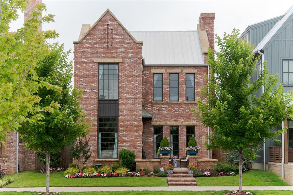 Timeless design meets modern comfort in this one-of-a-kind home on Oso Avenue. Blending historical aesthetics with intentional craftsmanship, this thoughtfully designed home offers warmth and character. The exterior features custom-colored mortar and locally quarried, hand-chiseled sandstone sills, adding a distinctive touch. Step inside through a grand entry framed by reclaimed brick arches, setting the tone for the inviting spaces within. Natural materials shine throughout, from stone countertops and oak flooring to solid brass hardware and bespoke lighting. The second-floor primary suite includes a private study, dual-vanity bathroom, and walk-in closet. Two additional bedrooms, a full bath, and a laundry room complete the upstairs. With thoughtful details at every turn, this home offers a perfect blend of style and comfort.