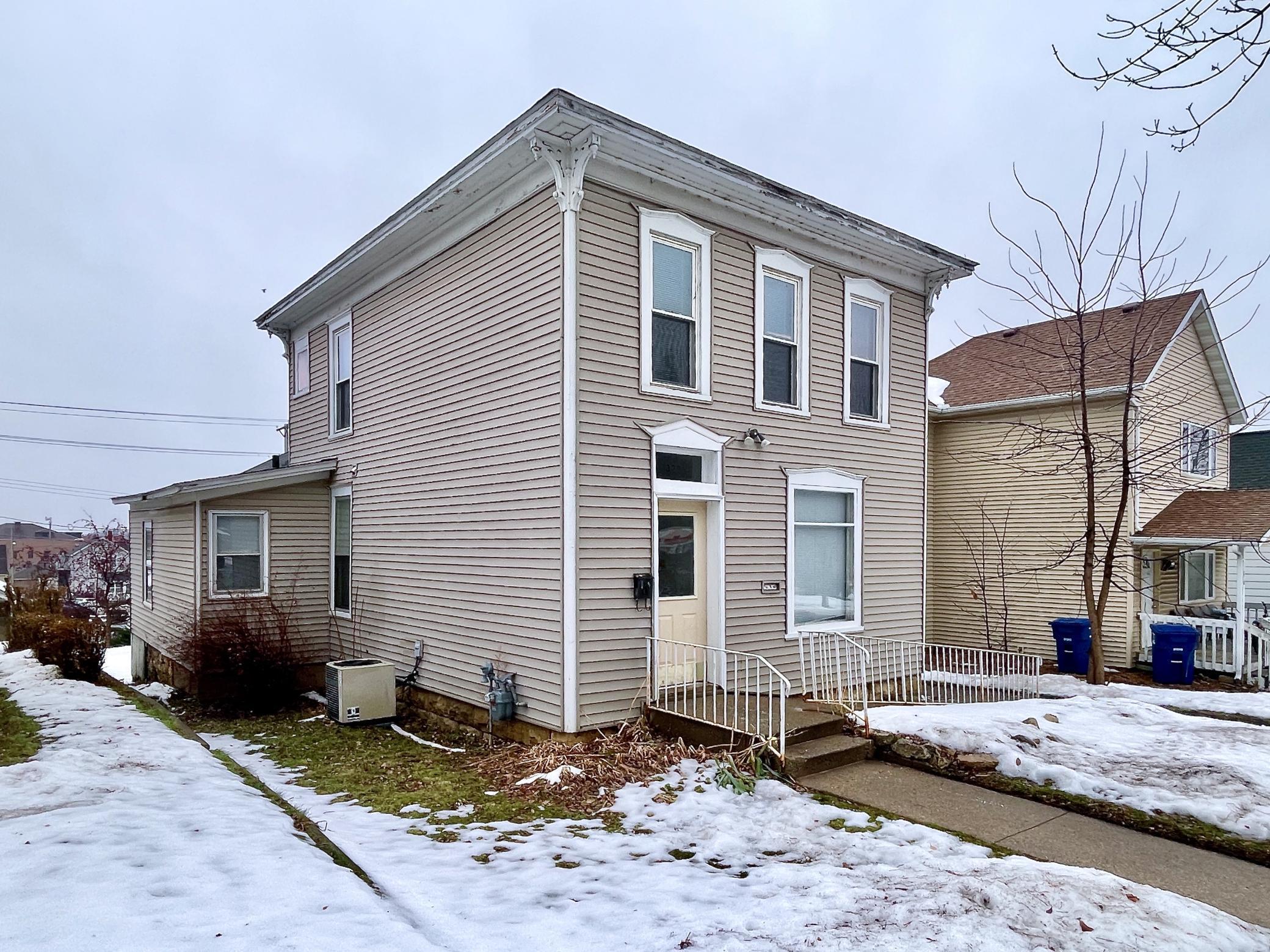 Great income opportunity! The main level unit of this Duplex has 2 bedrooms, a living room, dining room, full bath, kitchen, and pantry.  The owners put in luxury vinyl planking throughout the main floor unit and painted the entire interior this past summer.   The bathroom was completely redone with new flooring, toilet and vanity. A new countertop was installed in the kitchen. The range and refrigerator have been replaced in the last 2 years. The upper level unit is fully furnished and the items are negotiable.   This unit has a large eat in kitchen / living and dining area, one bedroom that has space for an office area, and a full bath that has a newer stackable washer and dryer in it.   The entryway to the building has new vinyl planking and fresh paint.   The water heater and whole building water softener system were installed in 2020. There is a detached 2 car garage with an upper level storage room.