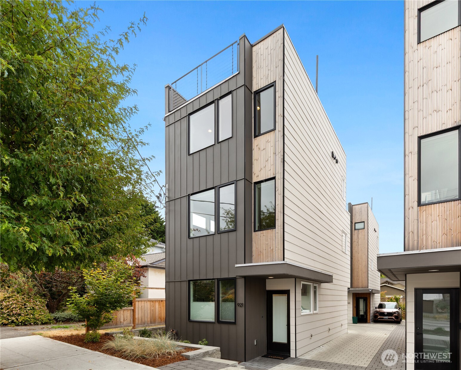 Completely detached, quality-built modern townhome on a quiet residential street—a rare find in the city! Built with an intentional approach to materials and detail, the home pairs clean-lined architecture with warm design. Wide-plank floors and a custom floating steel staircase with hardwood treads define the interior. An elegant kitchen features Abodian cabinetry, Bosch appliances, quartz surfaces, tiled backsplash, and abundant storage. Upstairs, the primary suite is a quiet retreat with a beautifully detailed tile shower and walk-in closet. Two additional bedrooms and a full bath complete the entry level. Enjoy gatherings with friends on the generous rooftop deck. Hunter Douglas blinds, efficient mini-splits for heating & cooling, EV charging, and off-street parking add everyday convenience. Centrally located near cafés, restaurants, groceries, and Trader Joe’s, with easy transit options connecting to downtown and the rest of the city! No HOA.