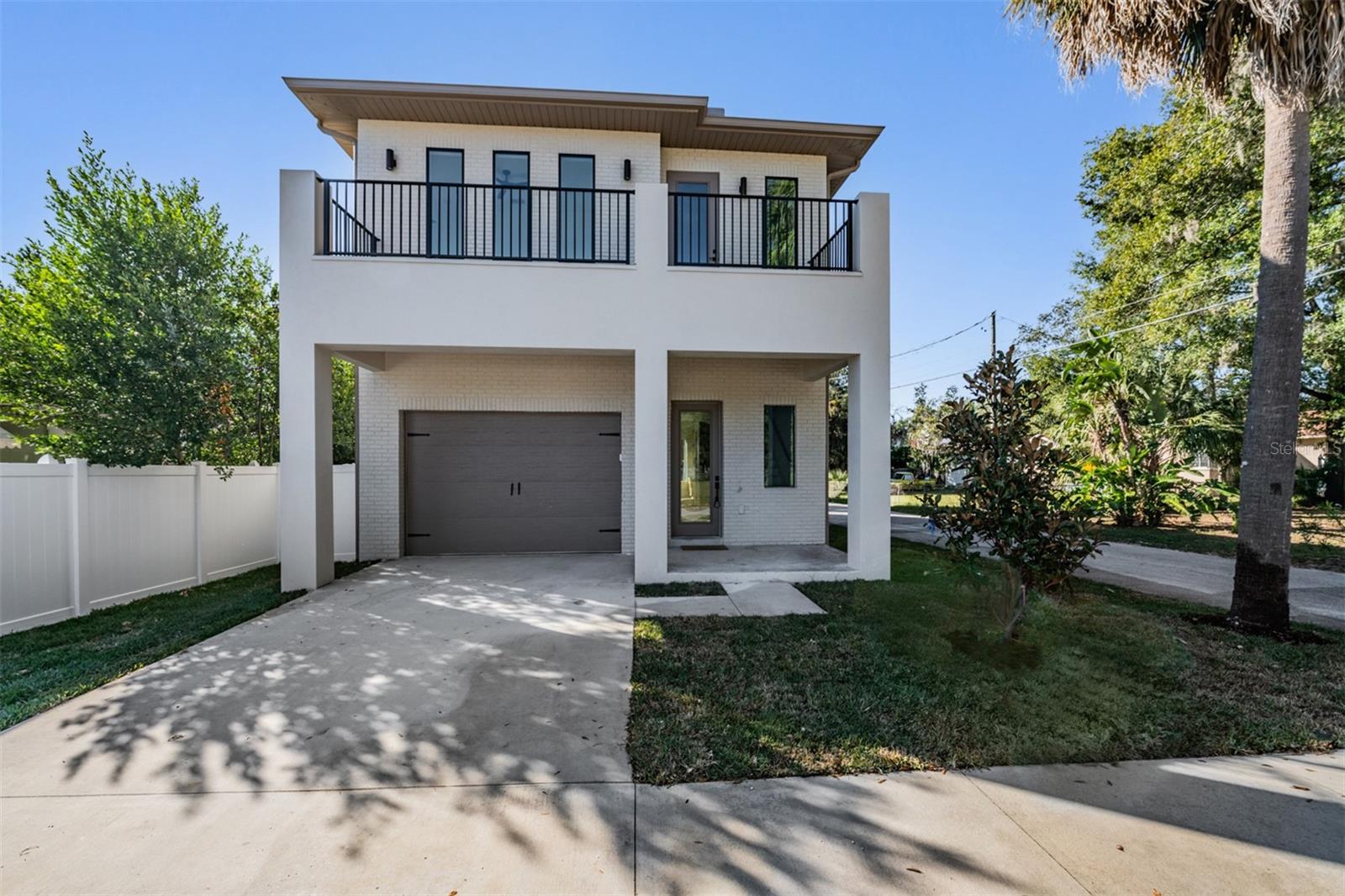 Under contract-accepting backup offers. Welcome to 3304 N Highland, a thoughtfully designed, modern residence where elevated design meets everyday comfort in one of Tampa’s most desirable pockets.This 3 bedroom, 2.5 bath home spans 2,168 square feet and immediately impresses with soaring 12 foot ceilings and striking all black aluminum windows that flood the space with natural light while delivering bold architectural impact. Wide plank engineered hardwood floors flow seamlessly throughout, setting the tone for a clean, contemporary aesthetic.The kitchen is a true centerpiece, featuring real white oak cabinetry, sleek TejMal quartz countertops, and a layout designed for both entertaining and daily living. Every detail feels intentional, refined, and timeless.Upstairs, the primary suite offers a private retreat with an oversized spa inspired shower, double vanity, and designer finishes that feel more boutique hotel than standard new construction. A private balcony extends the living space, perfect for morning coffee or evening unwinding.Outside, the fully fenced backyard is low maintenance yet incredibly inviting, complete with turf landscaping and tall Japanese blueberry trees that provide natural privacy and a serene backdrop.Additional highlights include a one car garage, modern baths with upscale finishes, and a layout that balances openness with functionality.This is not just a home, it is a lifestyle statement. Come experience 3304 N Highland in person and see why it stands apart. Homes with this level of design, space, and attention to detail do not last. Schedule your private showing and envision your next chapter here.
