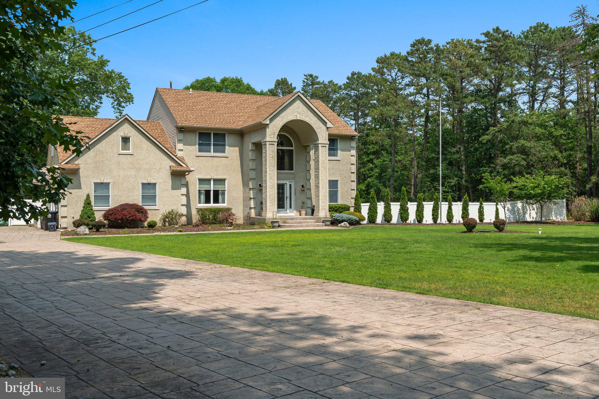 Welcome to your dream retreat in Waterford Township! Nestled at the end of a tranquil cul‑de‑sac, this stunning 3,603 sq ft colonial on nearly **5 acres** promises privacy and serene natural beauty.  **Built in 1994**, the home features a stucco exterior and professionally manicured grounds backing onto the vast conservation lands of Wharton Tract. Step inside the dramatic 2‑story foyer, where tile flooring guides you past elegant formal dining and living rooms, both with gleaming hardwood. French doors lead you into a sun‑filled sunroom that overlooks the expansive deck—perfect for morning coffee or entertaining. The spacious family room welcomes you with a cozy gas fireplace, recessed lighting & a ceiling fan. Entertain effortlessly in the expansive eat‑in kitchen, complete with: Center Island with breakfast bar, Electric stove, microwave & trash compactor, Decorative backsplash, tile floor & ceiling fan. A convenient half‑bath and laundry complete the first floor. Upstairs, discover four generous bedrooms boasting hardwood floors and ceiling fans, along with two full bathrooms. The master suite features plush carpeting, recessed lighting, a walk‑in closet, and a luxurious ensuite with jacuzzi tub, separate shower & dual vanities. Step down to the fully finished basement—tiled, partially tiled walls, recessed lighting, ceiling fans, and Bilco doors that open directly to a covered patio with skylights overlooking the fenced yard. Additional highlights include:A 21×24 “man‑cave/she‑shed” with tile flooring, detached one‑car backyard garage, Newer septic system & new roof installed in mid‑202, Dual‑zone heating & air, gas hot‑water heater (Feb 2020), separate fenced in yard for your dogs, small pond and chicken coop, and whole‑house generator. All of this is set on a beautifully landscaped 4.94‑acre lot, offering the ultimate in privacy and connection to nature—your very own daily oasis. Don’t miss the opportunity to own this exceptional property in a prime Waterford Township location!
