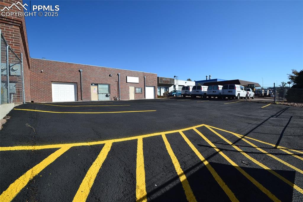 This industrial building offers 2,880 total square feet of flexible space suitable for automotive use, light industrial operations, or warehouse distribution. The property features a total of two bathrooms and can be leased as a whole or divided into two separate units, Side A and Side B, for individual tenants. It features an 8-foot-high by 8-foot-wide roll-up door and is fully fenced for added security. This versatile space is ideal for businesses needing functionality, flexibility, and secure access.