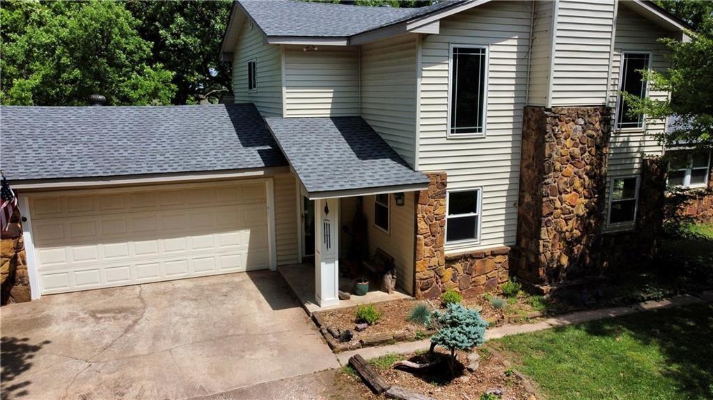 20K PRICE IMPROVEMENT!!! 
A circle drive and charming rock walls welcome you home to 1.72 acres of trees and tranquility. Waiting is a 3 bed/3 bath home as well as a second structure that is ready to be whatever you like. Currently a shop with a two car garage but the ideas are endless; home office, guest quarters, art studio...you decide! The primary home offers a stone fireplace surround in the living room that is two stories high and a kitchen perfectly positioned to serve the living room and the giant bonus/dining room at the rear of the home where the views await. A large laundry room is just inside as well. A secondary bedroom is a loft upstairs with loads of storage and one of the full baths. One underground storm cellar outside and one F5 rated above ground shelter in the secondary building will keep you covered! The property sits adjacent to a 60 acre horse ranch for so much privacy. Don't miss it!