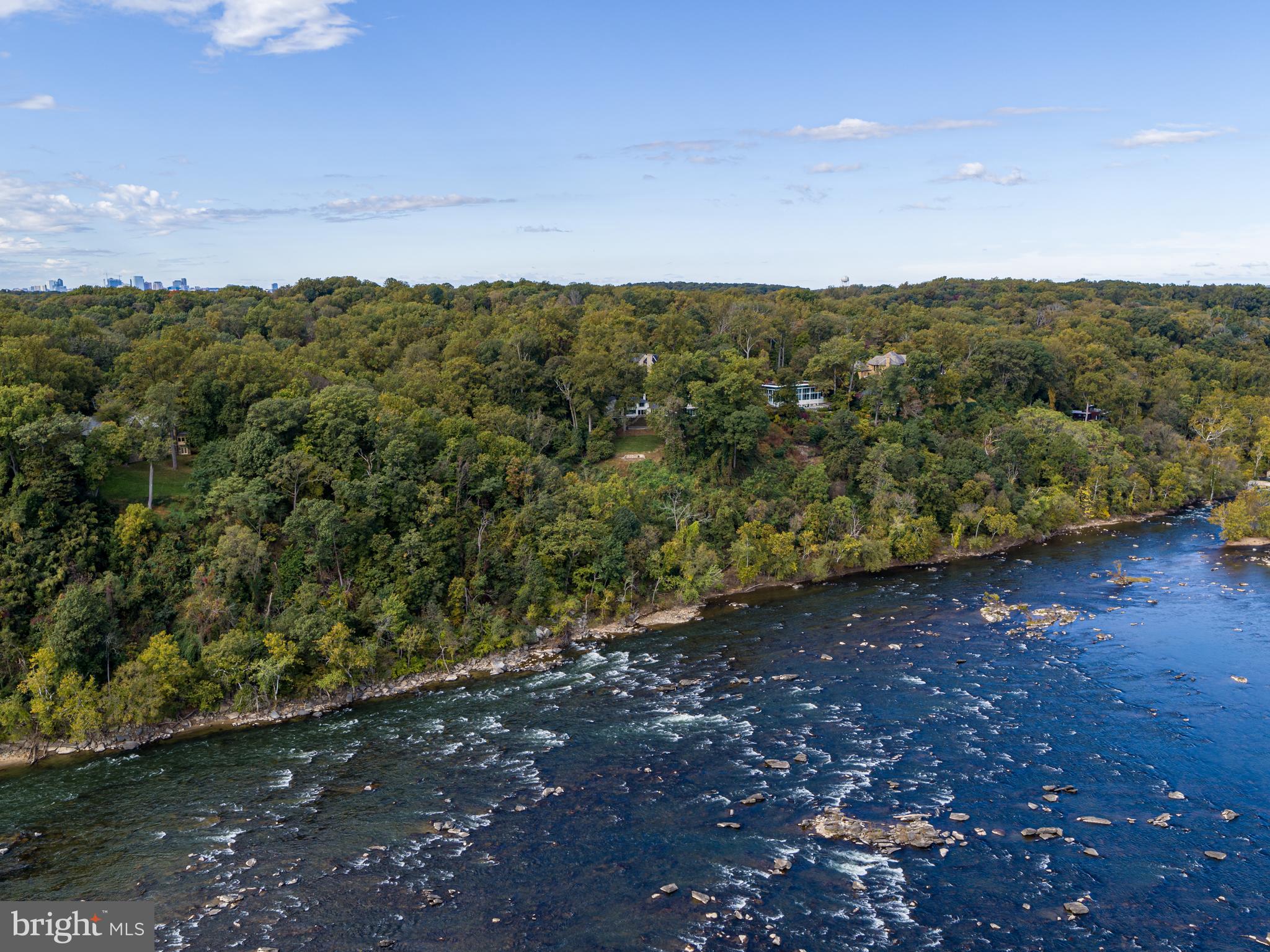 Easter Hill is the ultimate Washington riverfront estate encompassing two lots and 3.8 acres overlooking the most captivating, 270 degree views of the Potomac River. The site provides countless opportunities to create one of the region's finest estates. The existing residence provides a reference point for the opportunity which this exceptional site presents. The estate is ideally positioned on a gentle knoll which offers sweeping views in both directions along the river. In addition to the distant views, the estate affords privacy rarely available inside the Capital Beltway. The views capture the ever-changing moods of the Potomac River, providing a dynamic landscape which changes daily. Granite boulders punctuate the river in this location creating vibrant natural waterfalls and energy in the water as it flows towards the Chesapeake Bay. Abundant wildlife also seeks refuge here from the nearby city, and a wide range of Bald Eagles, Peregrine Falcons, and Red-Tailed Hawks are often visible overhead and along the water's edge. These natural wonders are clearly visible from the protected vantage point at Easter Hill. The estate is strategically located less than one mile from the District of Columbia and just over five miles to the White House. Offering extraordinary views, privacy, security, and two buildable sites, Easter Hill is the finest opportunity for a world-class estate along McLean's coveted Gold Coast.